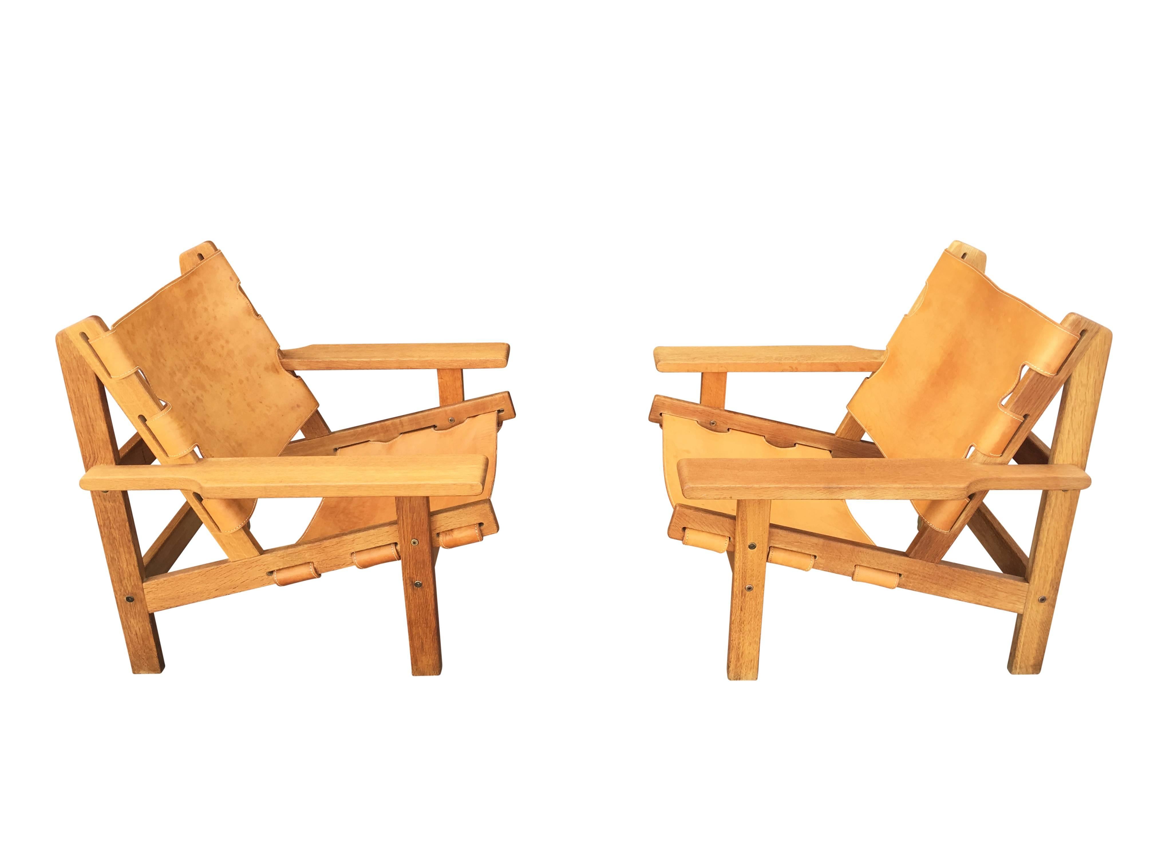 Pair of Kurt Ostervig lounge chairs in thick cognac leather on a solid oak frame. Fantastic, patina. Produced by KP Jorgensens Mobelfabrik, model 168.
