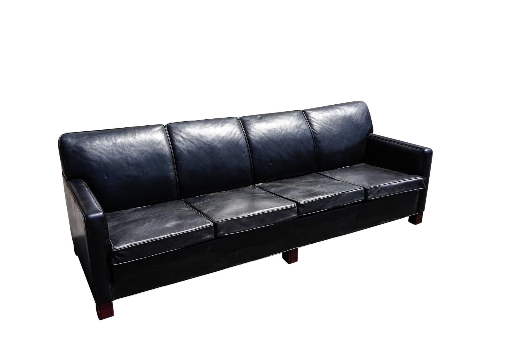 Large Danish four-seat leather sofa, circa 1950 in the style of Flemming Lassen. Very nice quality and design.