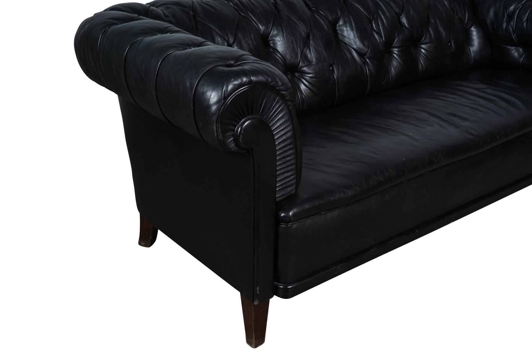 Vintage black leather Chesterfield sofa. Great patina and wear.