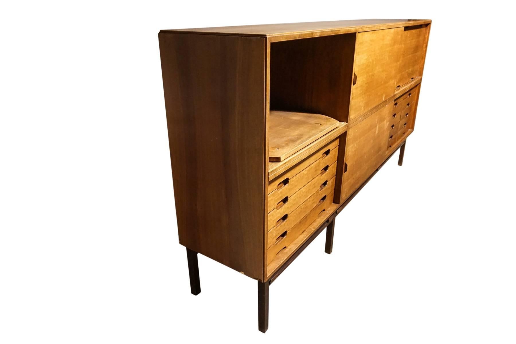 Rare vintage Ilmari Tapiovaara sideboard manufactured by La Permanente Mobili Cantu, Italy, circa 1960. Walnut cabinet with sliding doors, drawers, and original brass hardware.