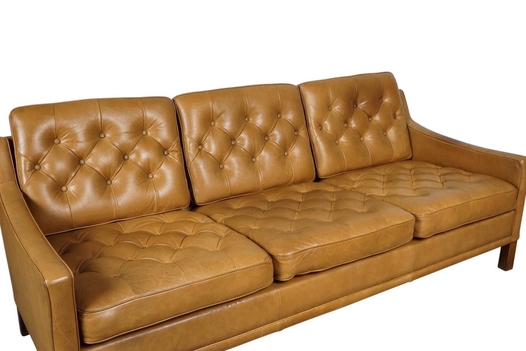 Swedish Mid-Century sofa designed by Ib Kofod-Larsen, manufactured by OPE. Cognac colored leather with buttoned cushions, circa 1960.