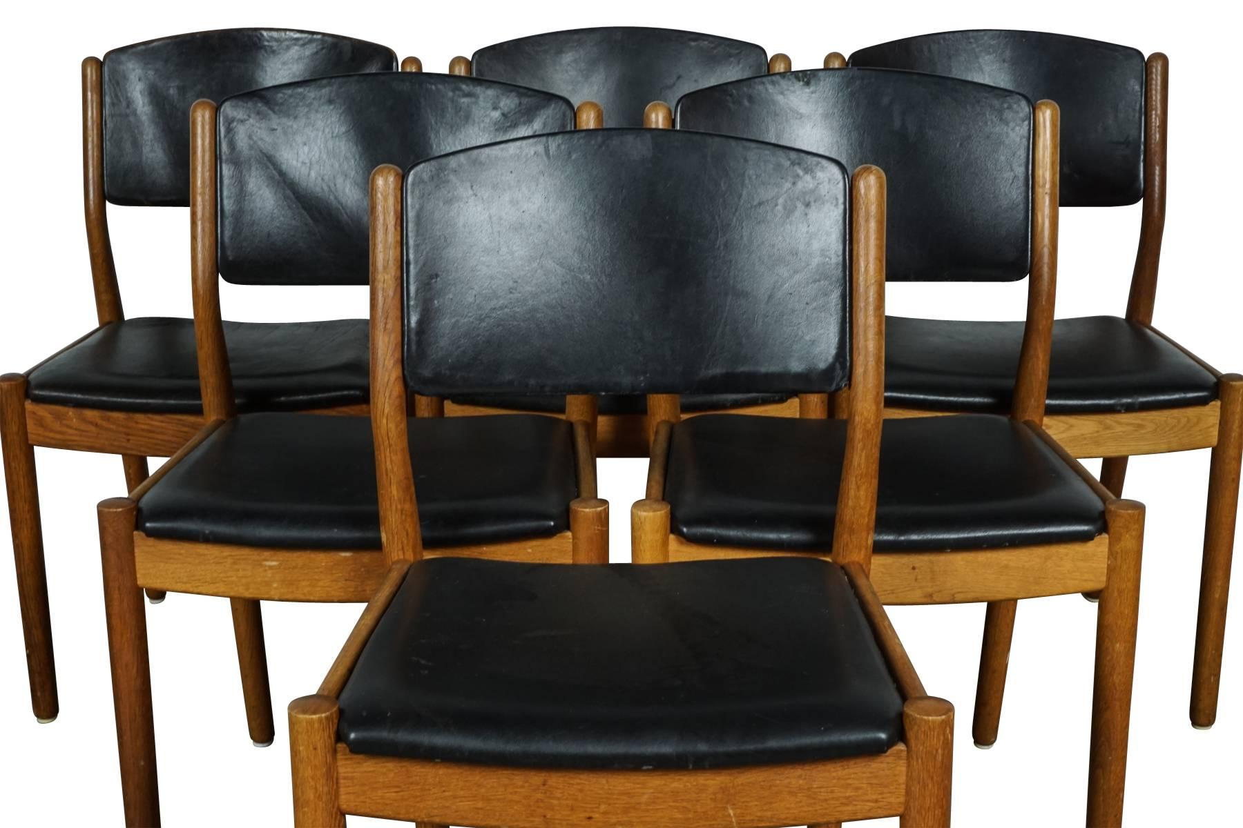 Set of six dining chairs designed by Poul M. Volther, model J61, circa 1960. Solid oak frame with black leather seats and back. Manufactured by FDB, Denmark.