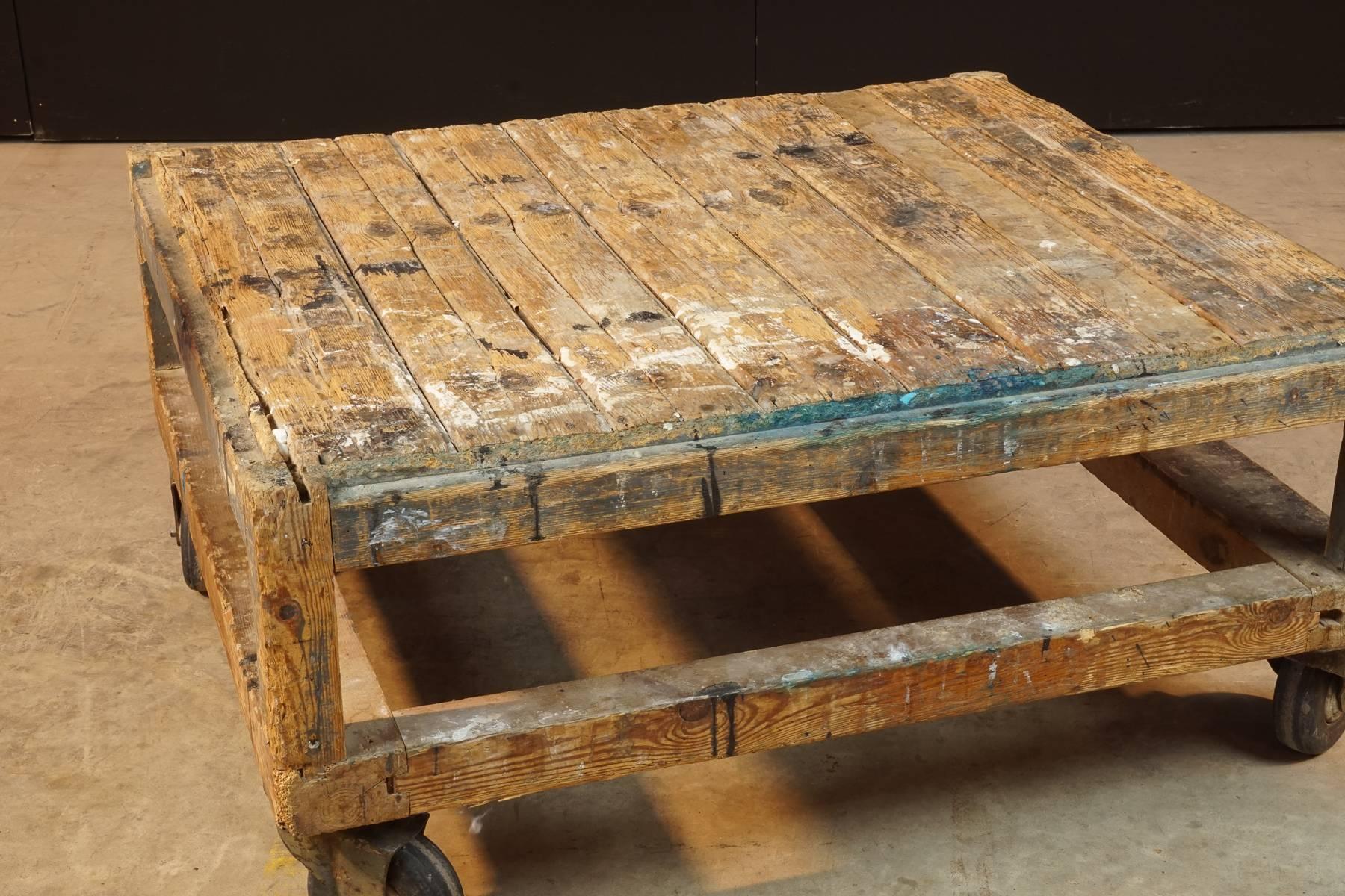 French artist's coffee table on casters, circa 1950. Surface with paint and wonderful patina.