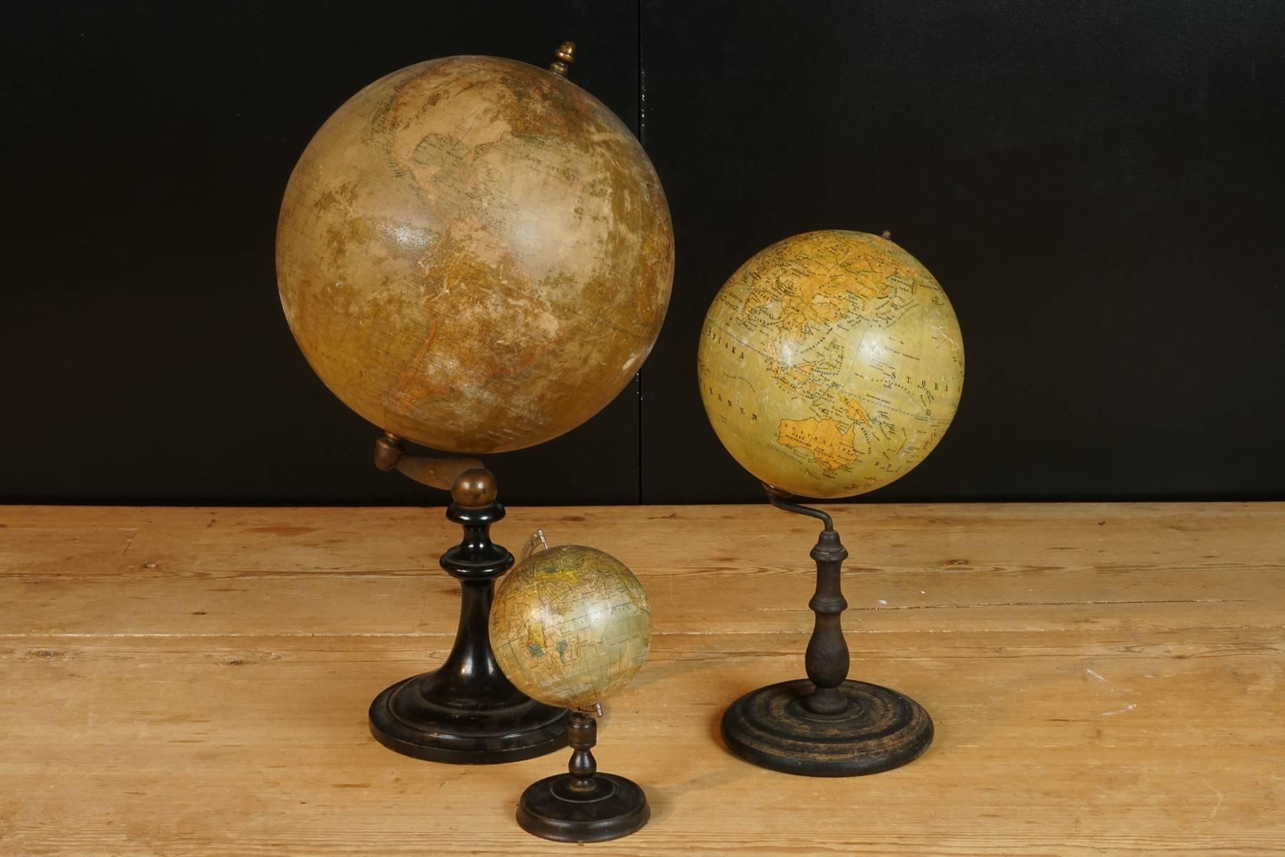 Collection of three globes, circa 1930. The three globes are made in France, Sweden and Japan.