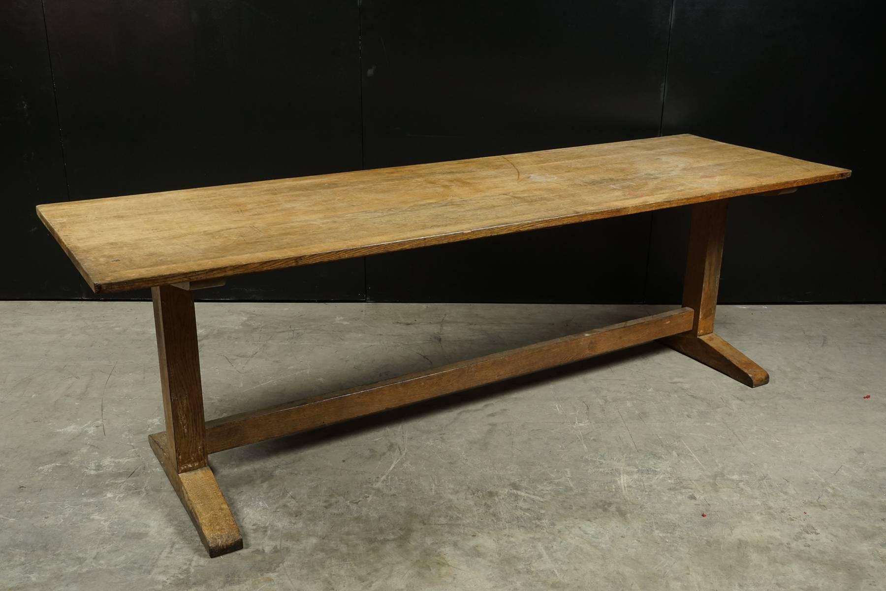 Oak dining table from England, circa 1960. Large model with solid construction, presumably from a university.