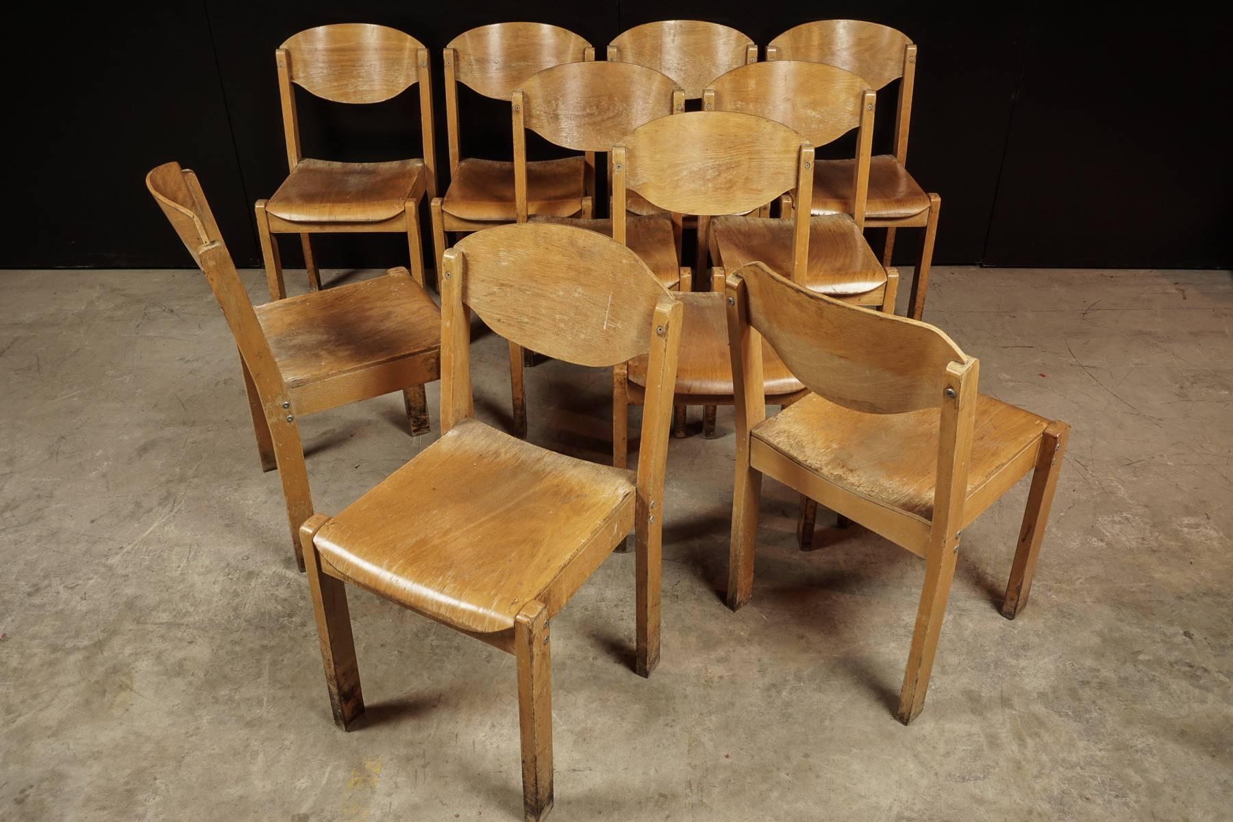 Set of ten stacking chairs from a University in France, circa 1960. Ergonomic design made of durable bent wood. 18 available.
