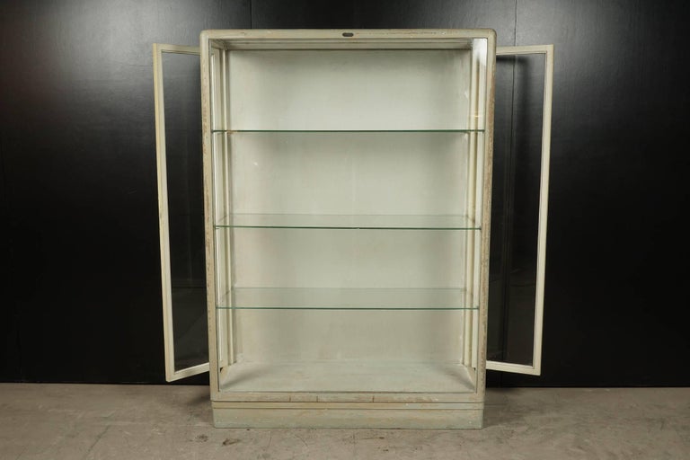 French Glass Display Cabinet, Circa 1940.  Original paint with three shelves and glass doors on both sides.  Key Included.  Maker's label on the front.