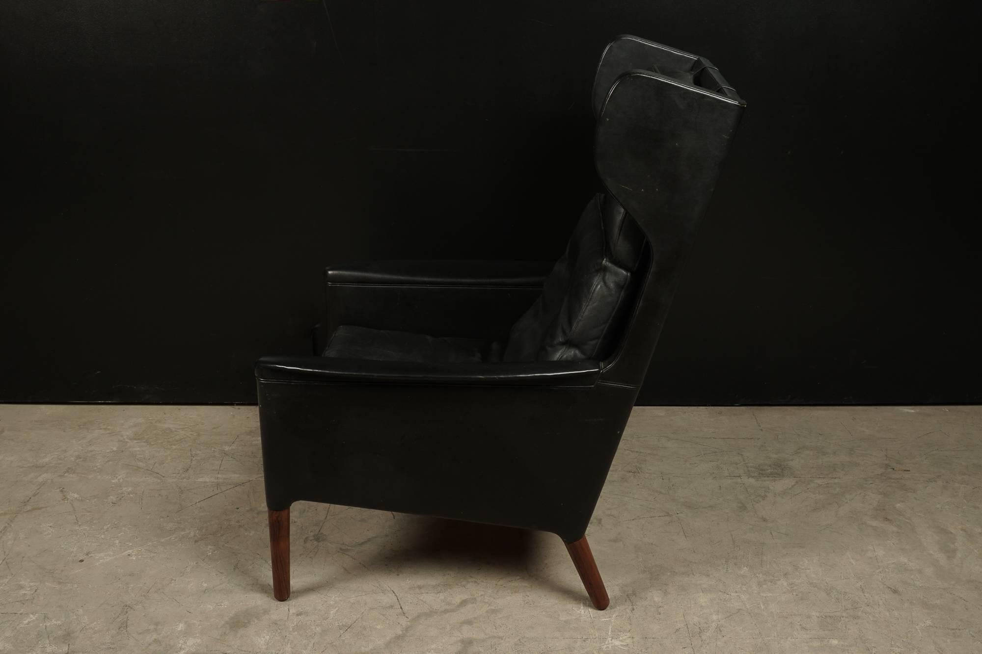 Kurt Ostervig leather wing back chair from Denmark, circa 1970. Supple black leather with rosewood feet.