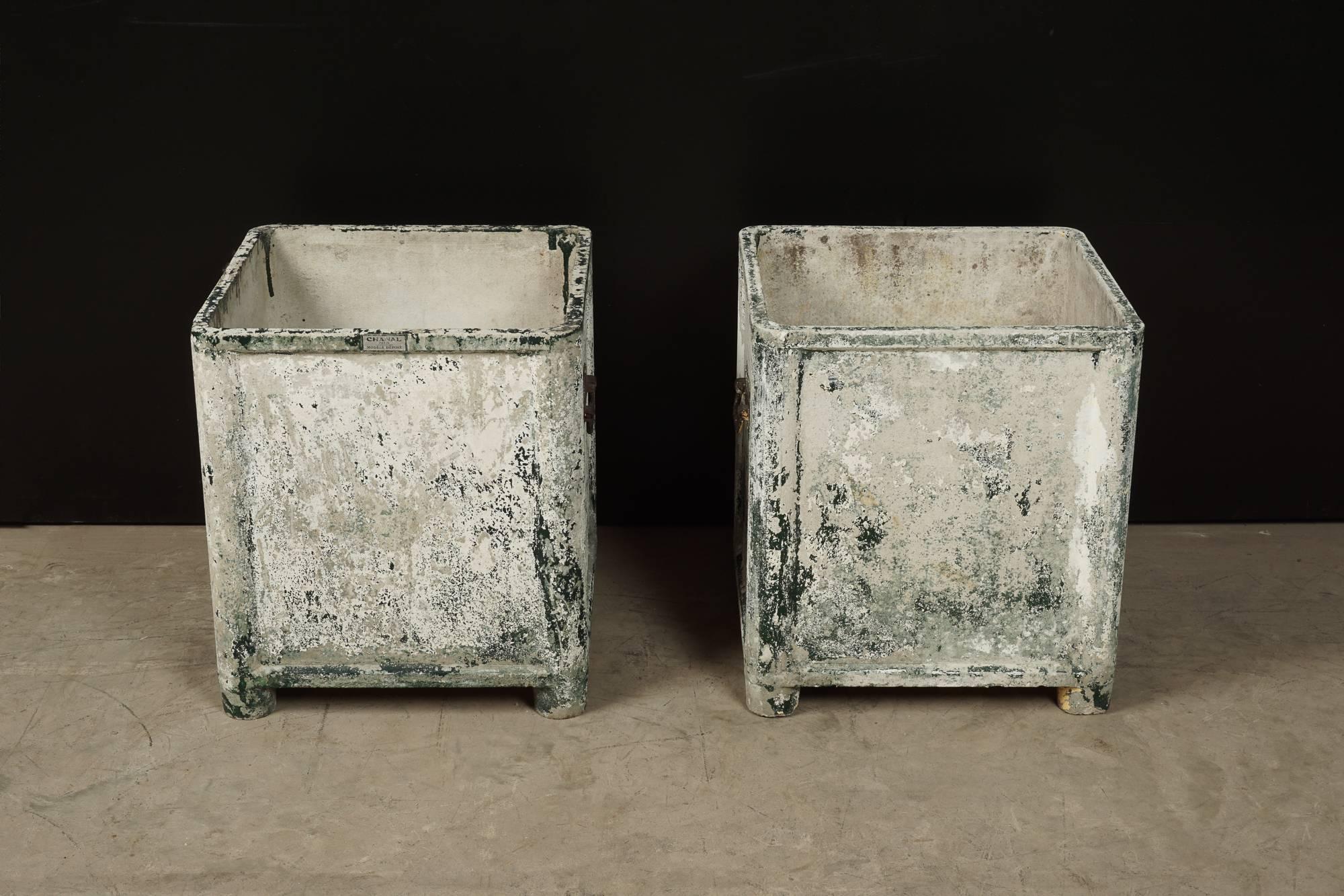 Pair of plaster and fiberglass planters manufactured by Chanal, Paris. Original hardware and patina.