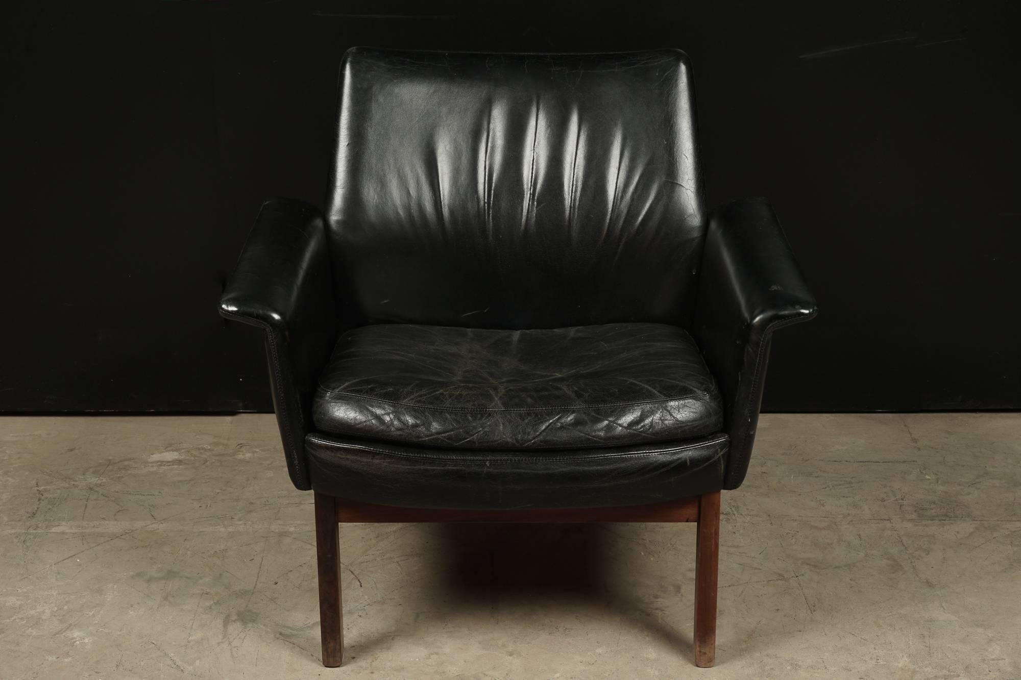 Mid Century Lounge Chair in Leather From Denmark, Circa 1970.  Black leather with a solid teak base.