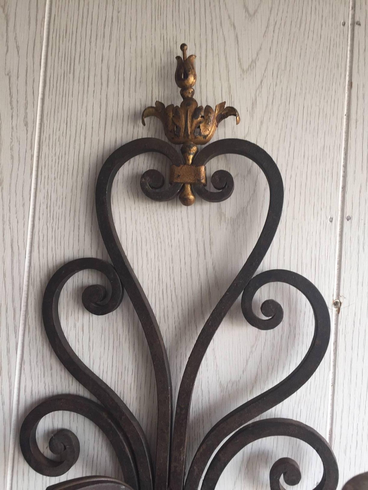 Pair of iron sconces with gilt accents. Circa 1920's.