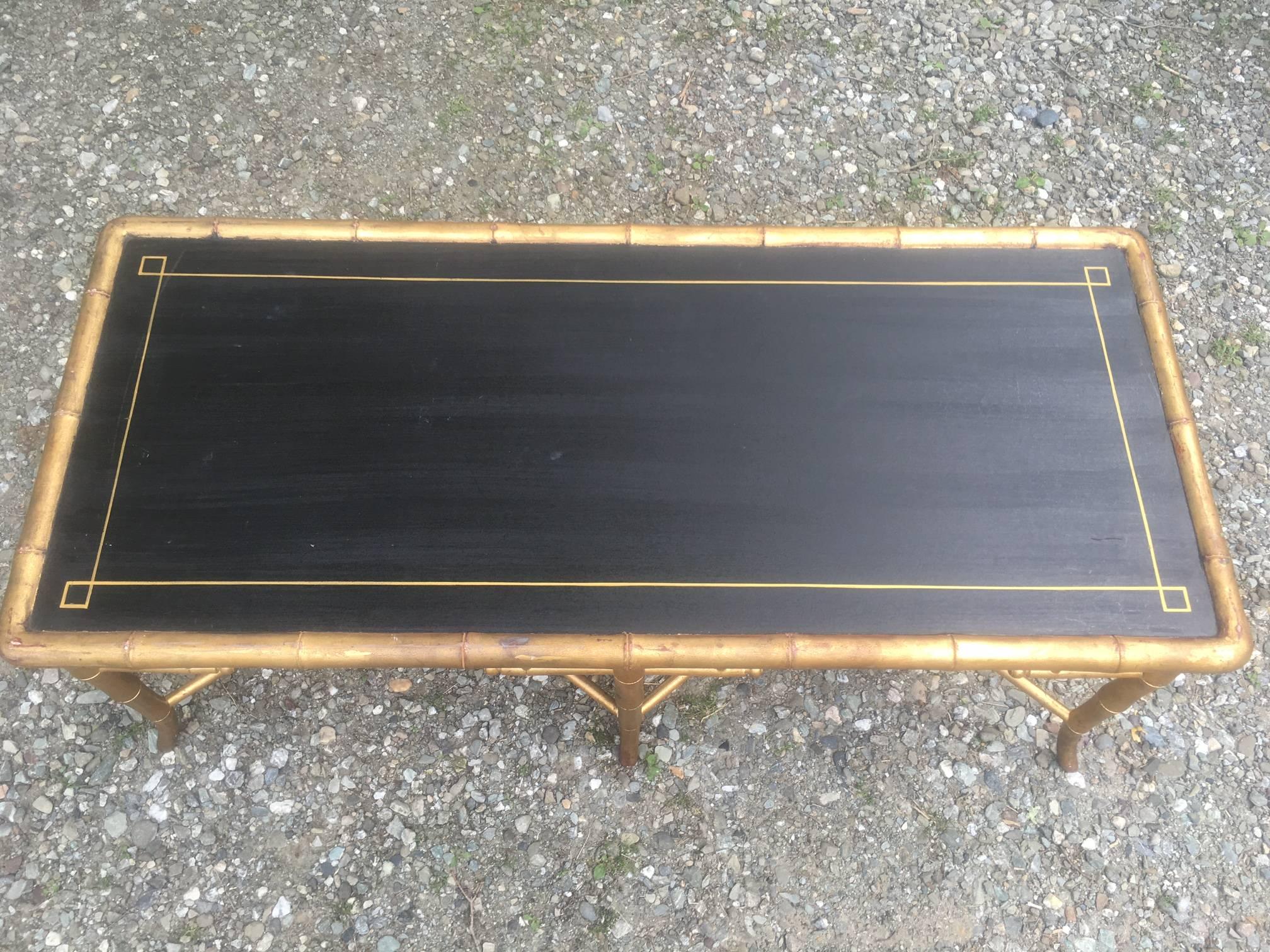 Giltwood base with black wood top.