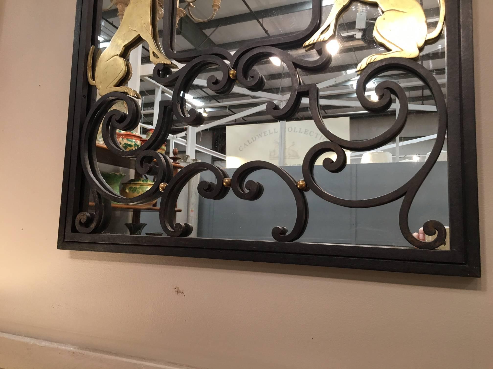 Art Deco iron mirror with brass dogs. Part of the inventory purchased from the Robert Altman Shop in NYC.