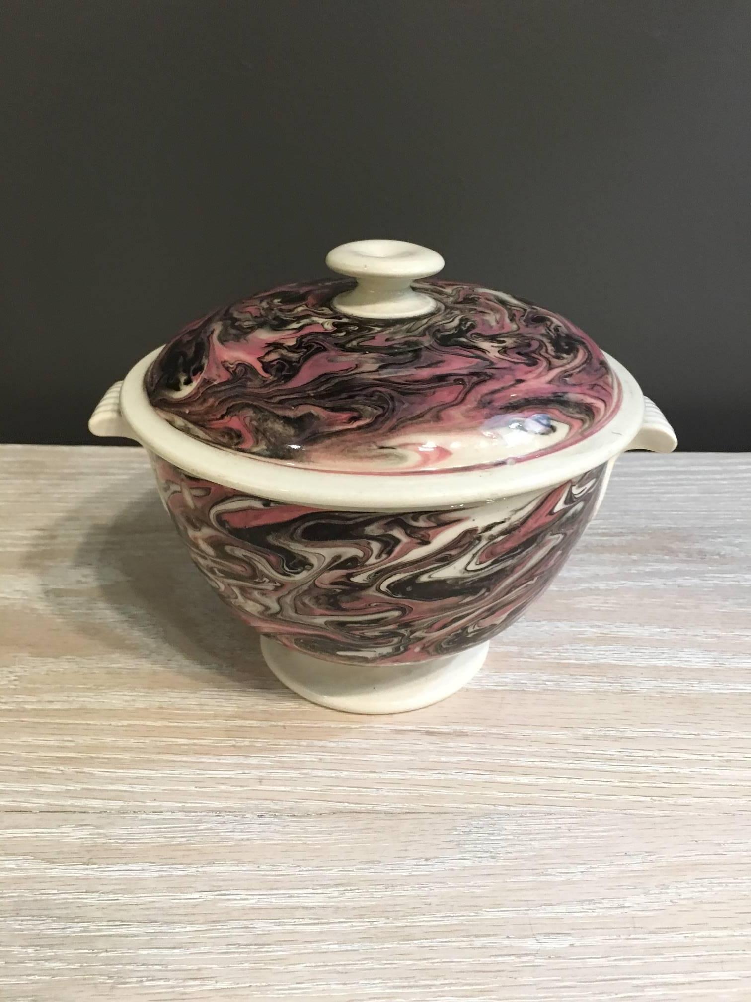French pottery tureen with lid in pink and brown swirl.