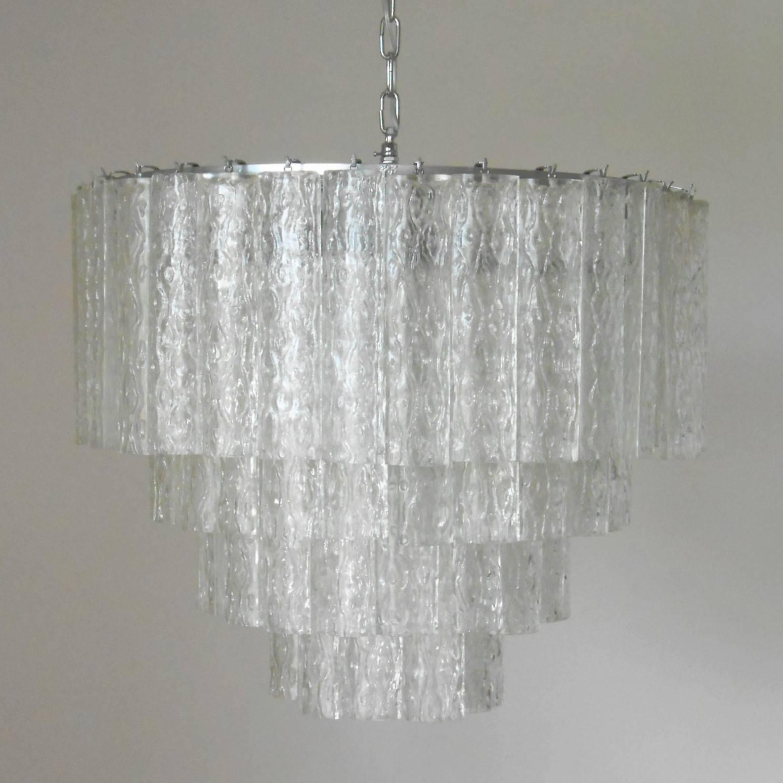 Vintage Italian chandelier with clear Murano glass tubes blown into beautiful oval shapes with textured designs, mounted on a tiered silver metal frame / Designed by Venini circa 1960’s / Made in Italy 
12 lights / E12 or E14 type /  max 40W