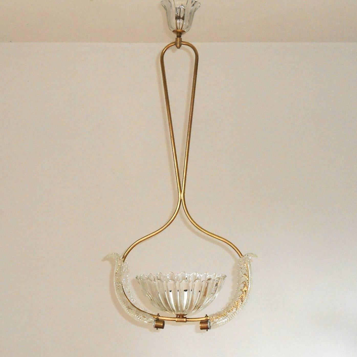 Vintage Italian pendant chandelier with  clear Murano glass with textured scalloped design, mounted on brass frame / Designed by Ercole Barovier circa 1950’s / Made in Italy
1 light / E26 type / max 60W each
Height: 34 inches / Width: 17 inches /