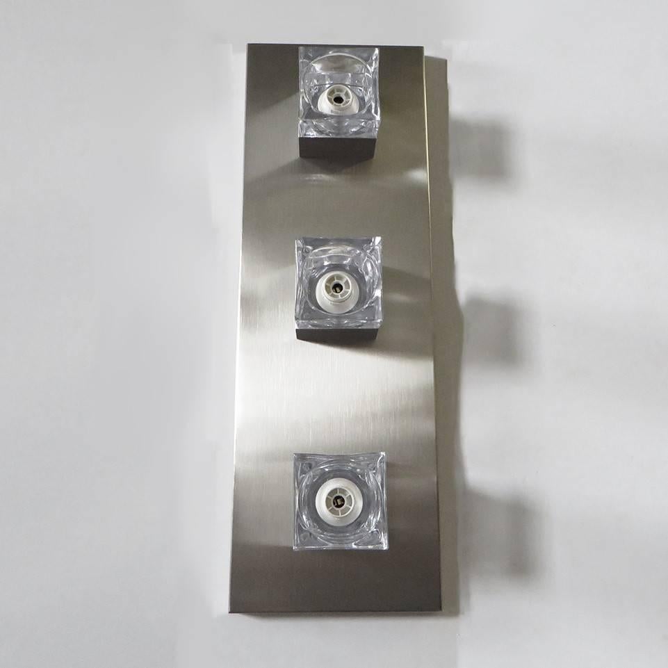 Vintage Italian wall lights with clear glass cubes mounted on rectangular brushed nickel frame, by Sciolari / Can be used vertically, horizontally or as a flush mount / Made in Italy in the 1960’s
3 lights / E12 or E14 type / max 40W each
Height: 24