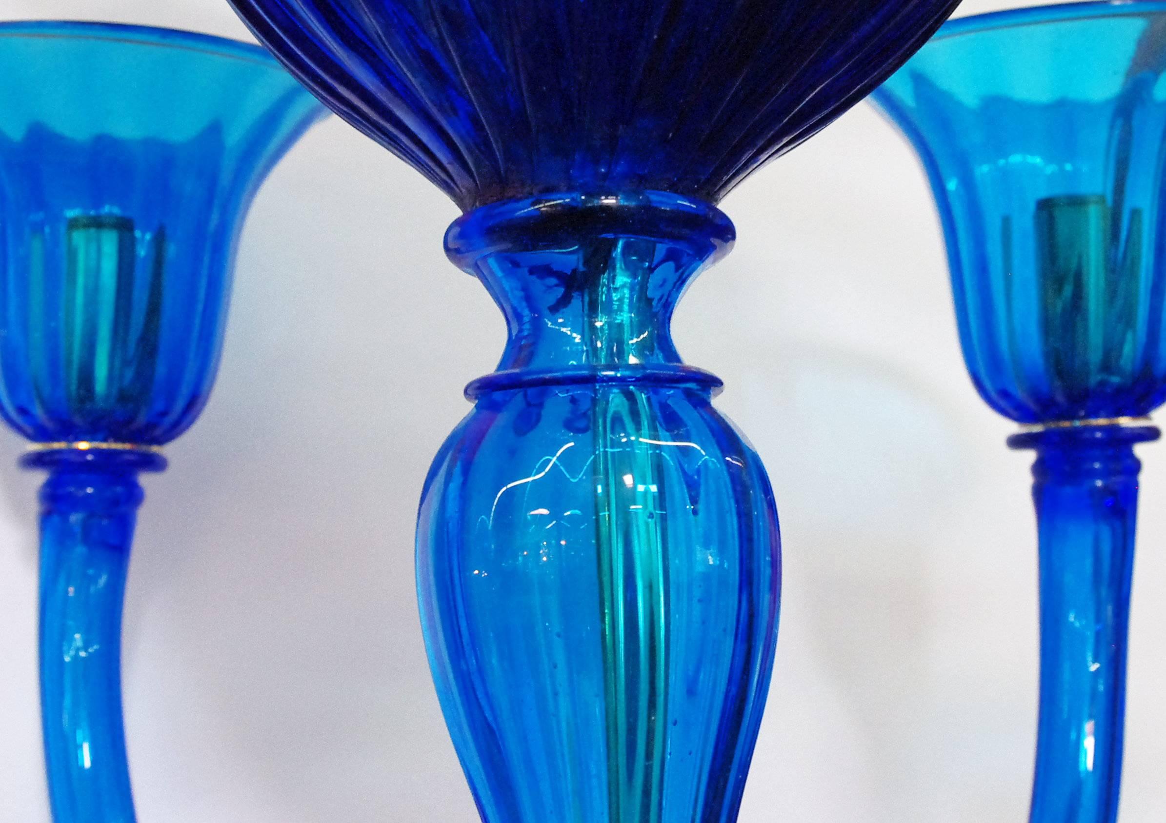Vintage Italian chandelier with blue Murano glasses hand blown with textured curves, mounted on two tiers / Designed by Barovier e Toso circa 1970’s / Made in Italy 
18 lights / E12 or E14 type / max 40W each
Diameter: 42 inches / Height: 58 inches