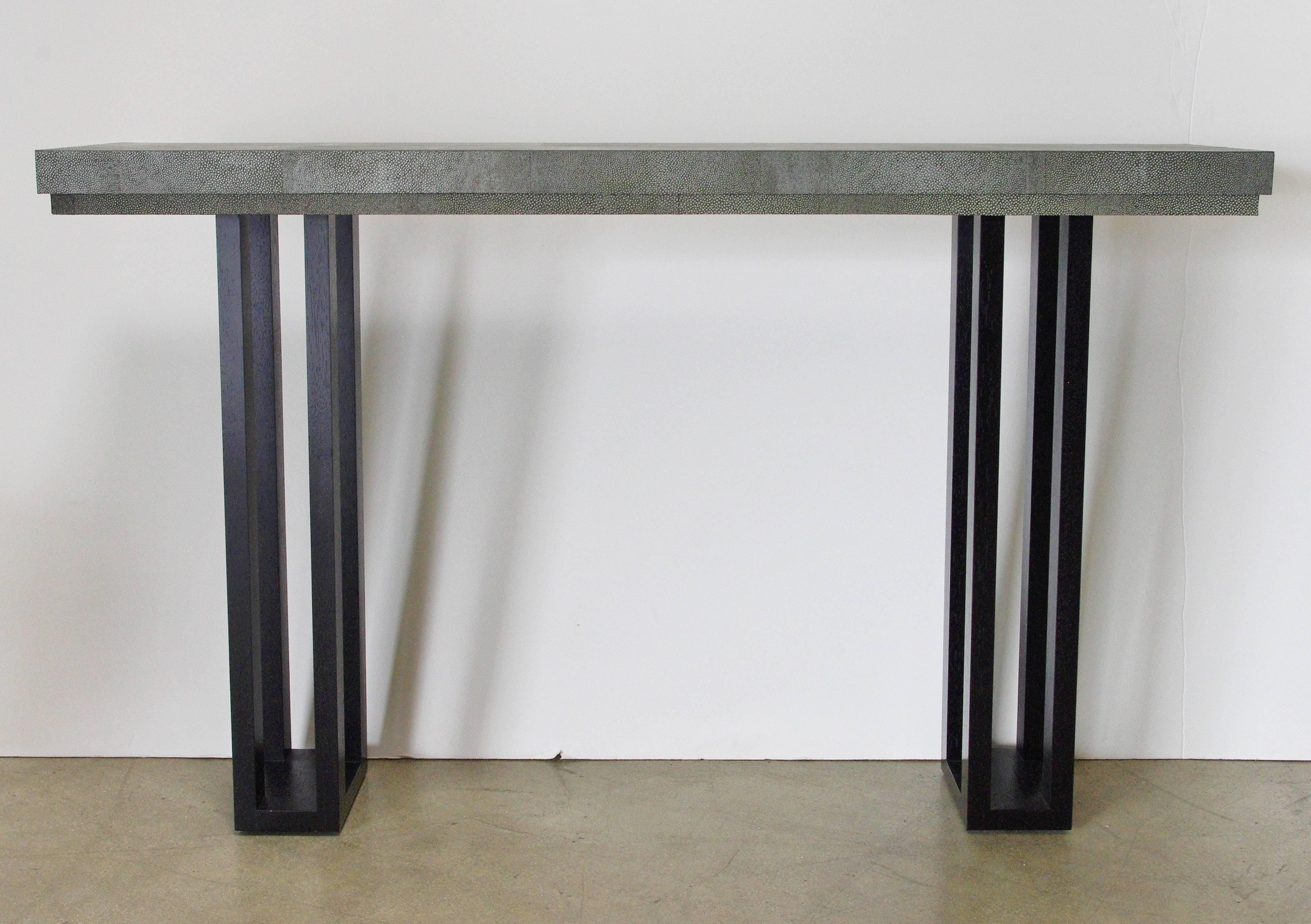 Grey green faux shagreen leather covered wood top console table with black wooden legs. 
Can be custom ordered.