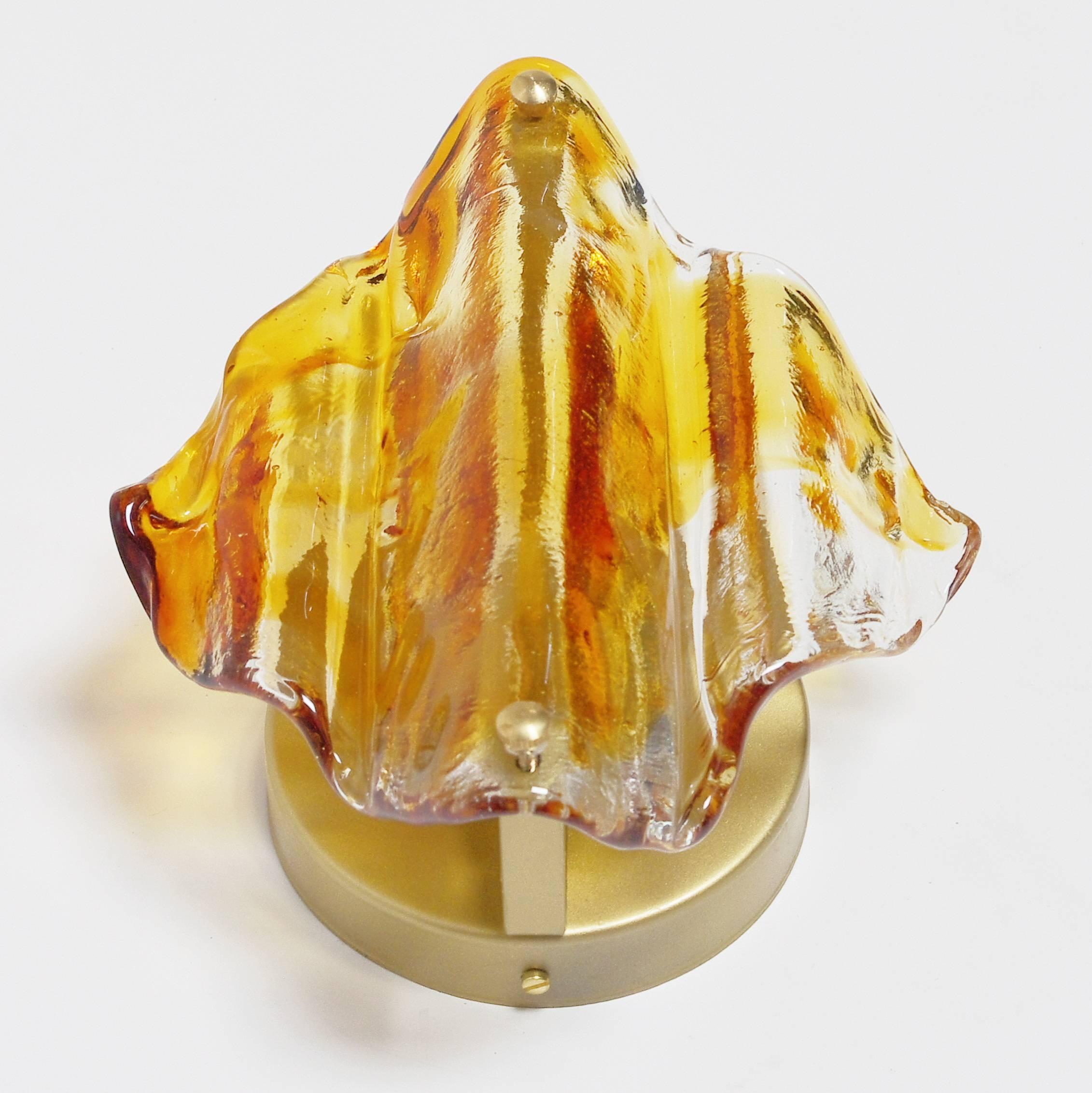 Vintage Italian wall light or flush mount with diffused amber and clear Murano glass hand blown to produce a contorted diamond piece, mounted on brass back plate / One minor crack in the top of the glass due to wear and tear / Designed by Mazzega,