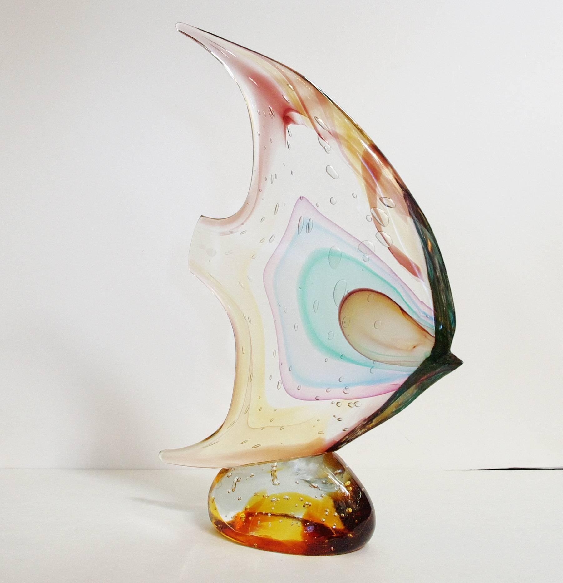 Italian Murano glass fish on pebble sculpture, hand blown and crafted in multiple colors of Murano glass by Sergio Constantini 
Signed “Constantini S.” on the base / Made in Italy in the 1980’s
Height: 18 inches / Width: 13 inches / Depth: 3.5