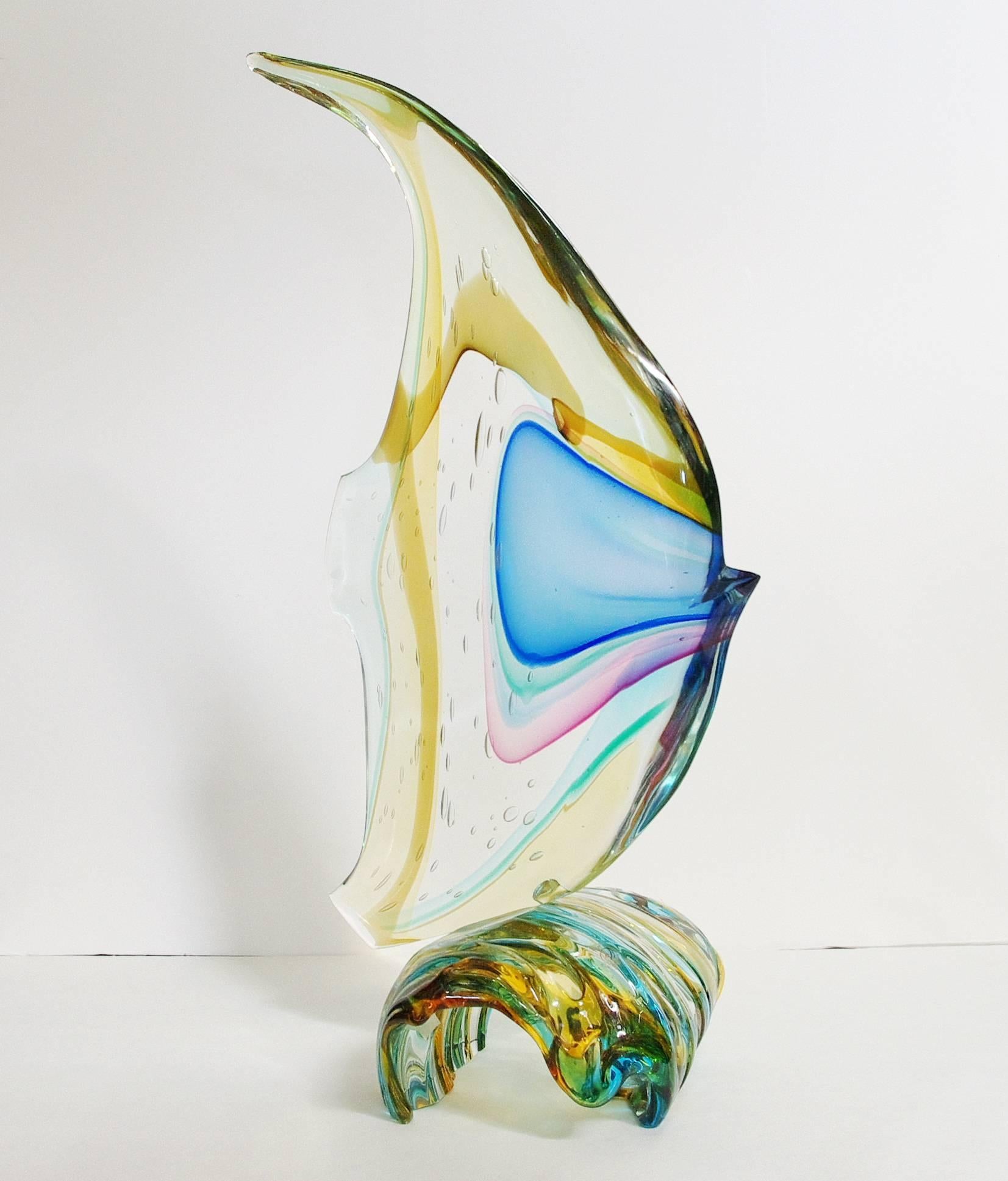Italian Murano glass fish on wave sculpture, hand blown and crafted in multiple colors of Murano glass by Sergio Constantini 
Signed “Constantini S.” on the base / Made in Italy in the 1980’s 
Height: 23.5 inches / Width: 13 inches / Depth: 9 inches