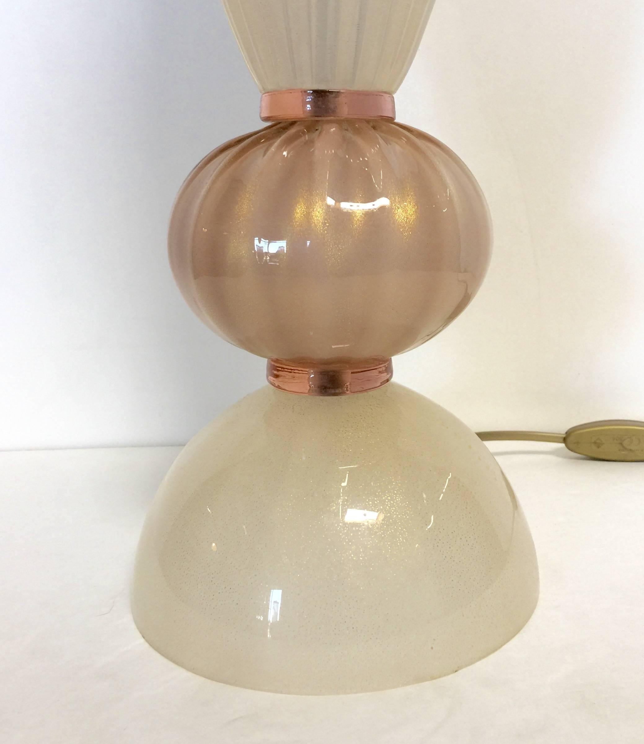 Pair of Italian Murano glass pink and cream table lamps. 
Price listed is for the pair.
Single light socket / wired for U.S.