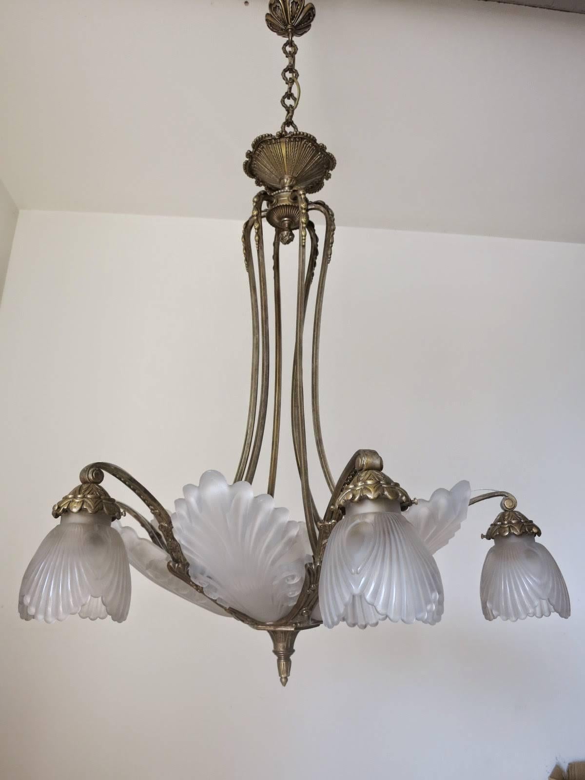 French Art Deco chandelier with frosted glass and bronze frame. 
12 light sockets / wired for U.S.