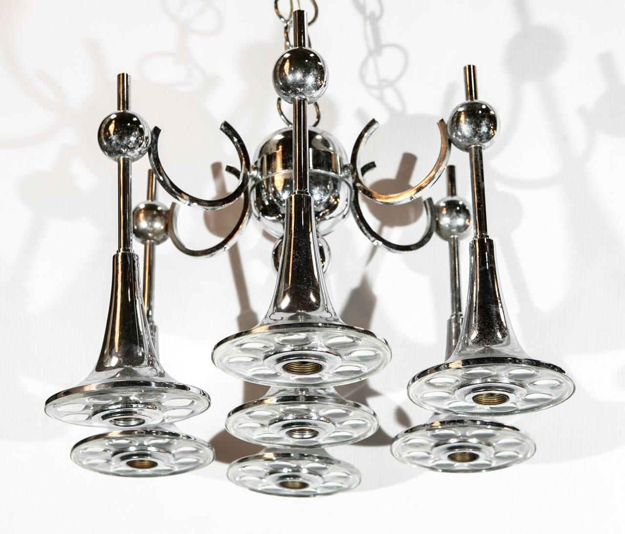 Vintage Italian chandelier made with seven clear Murano glasses and chrome metal / Designed by Gaetano Sciolari circa 1970’s / Made in Italy
7 lights / E12 or E14 type / max 40W each
Diameter: 19 inches / Height: 12 inches plus chain and canopy
1 in