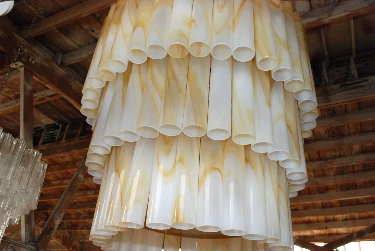 Vintage Italian chandelier with cream and caramel Murano glass tubes hand blown to produce a marbled effect, mounted on cream painted metal frame / Designed by Venini circa 1970’s / Made in Italy 
9 lights / E26 or E27 type / max 60W each
Diameter: