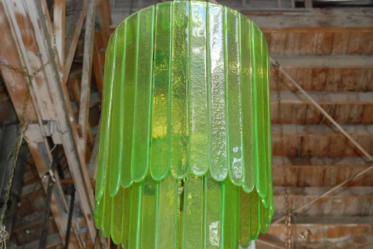 Vintage Italian chandelier with green Murano glasses tiered on chrome metal frame to produce a cascade effect / Designed by Leucos circa 1970’s / Made in Italy
9 lights / E26 or E27 type / max 60W each
Diameter: 20 inches / Height: 39 inches plus