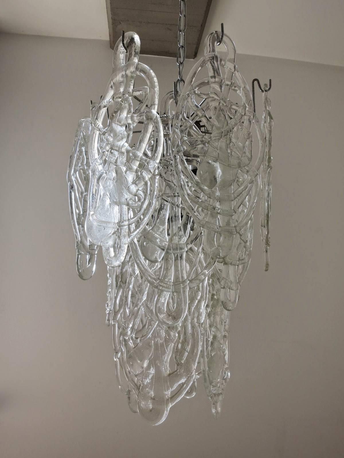 Vintage Italian chandelier with 16 clear Murano glasses hand blown to artistically resemble a cobweb, mounted on chrome frame / Designed by Vistosi circa 1960’s / Made in Italy
4 lights / E12 or E14 type / max 40W each
Diameter: 14 inches / Height:
