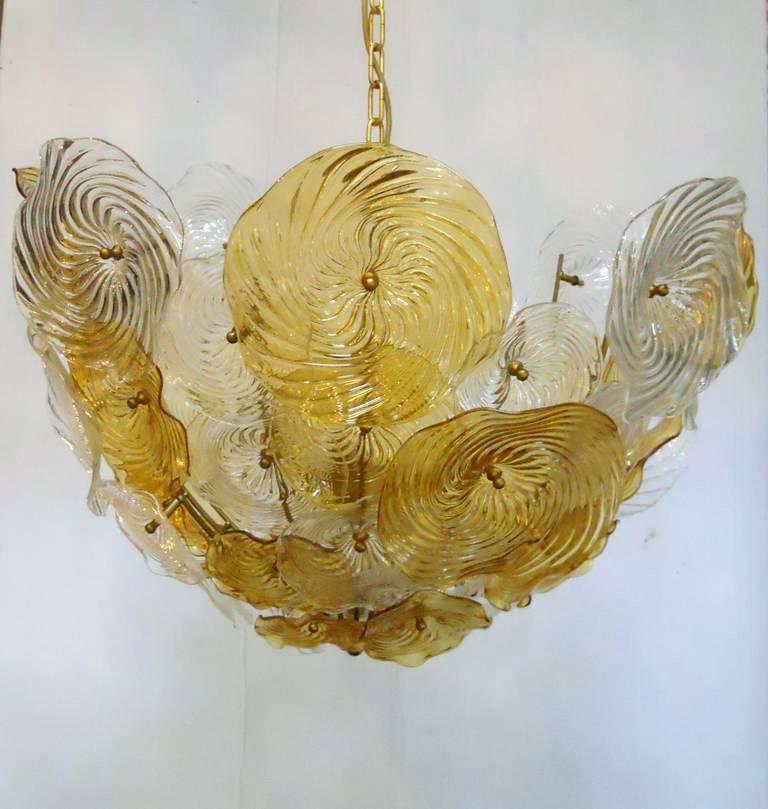 Vintage Italian chandelier with amber and clear Murano glass discs hand blown with spiraled texture, mounted in an intricate pattern on brass frame / Made in Italy circa 1960's
5 lights / E12 or E14 type / max 40W each
Diameter: 28 inches / Height: