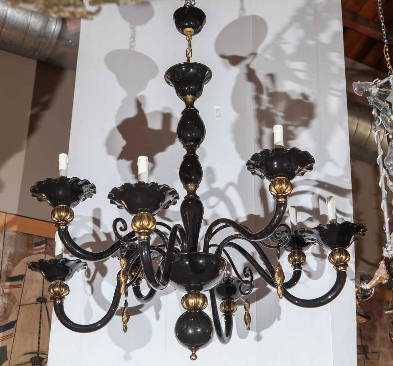 Italian Venetian chandelier with hand blown black Murano glass and gold Murano glass details / Made in Italy circa 1960’s
8 lights / E12 or E14 type / max 40W each
Diameter: 40 inches / Height: 51 inches plus chain and canopy
1 in stock in Palm