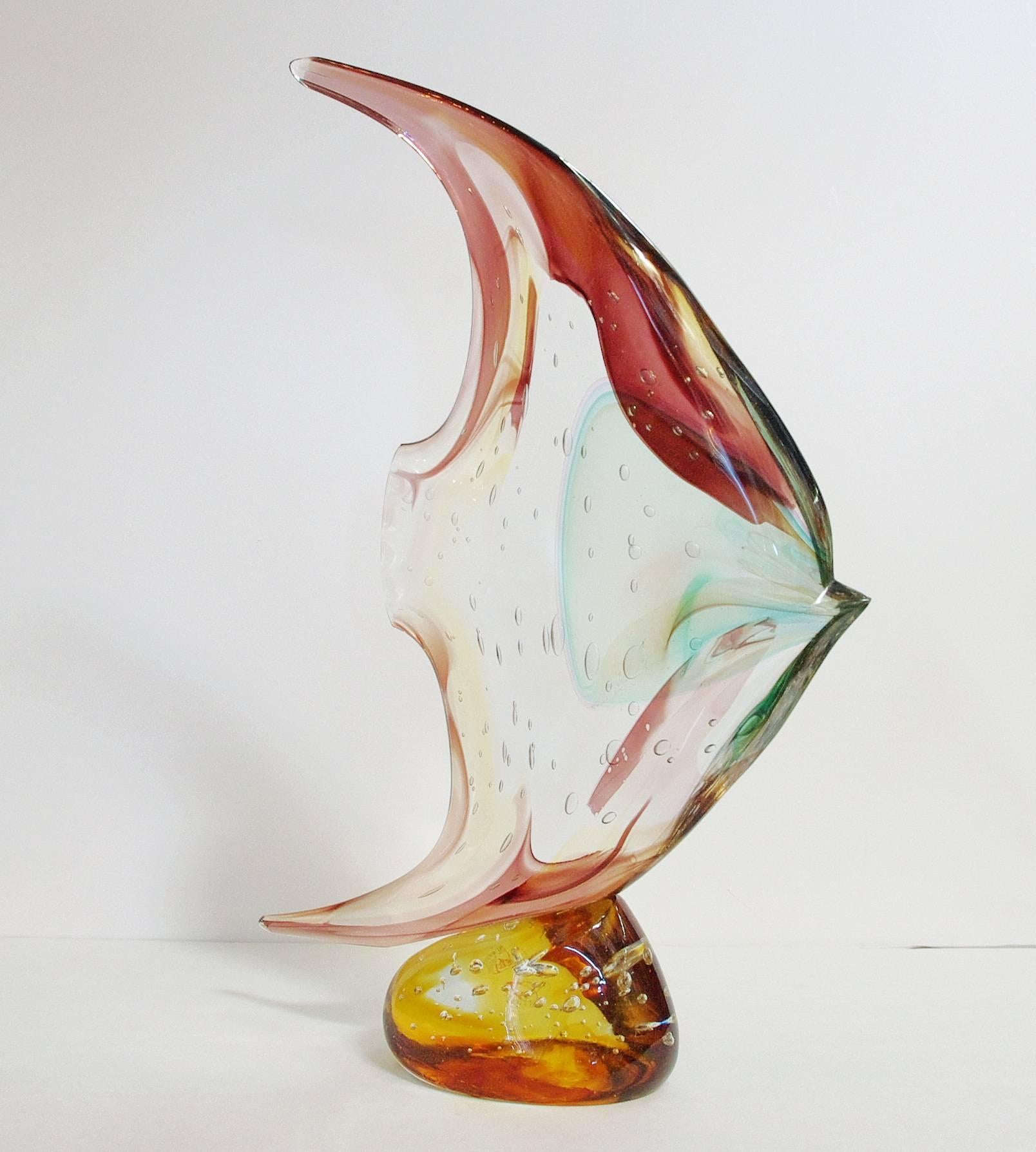 Italian Murano glass fish on pebble sculpture, hand blown and crafted in multiple colors of Murano glass by Sergio Constantini 
Signed “Constantini S.” on the base / Made in Italy in the 1980’s 
Height: 20 inches / Width: 14 inches / Depth: 4 inches