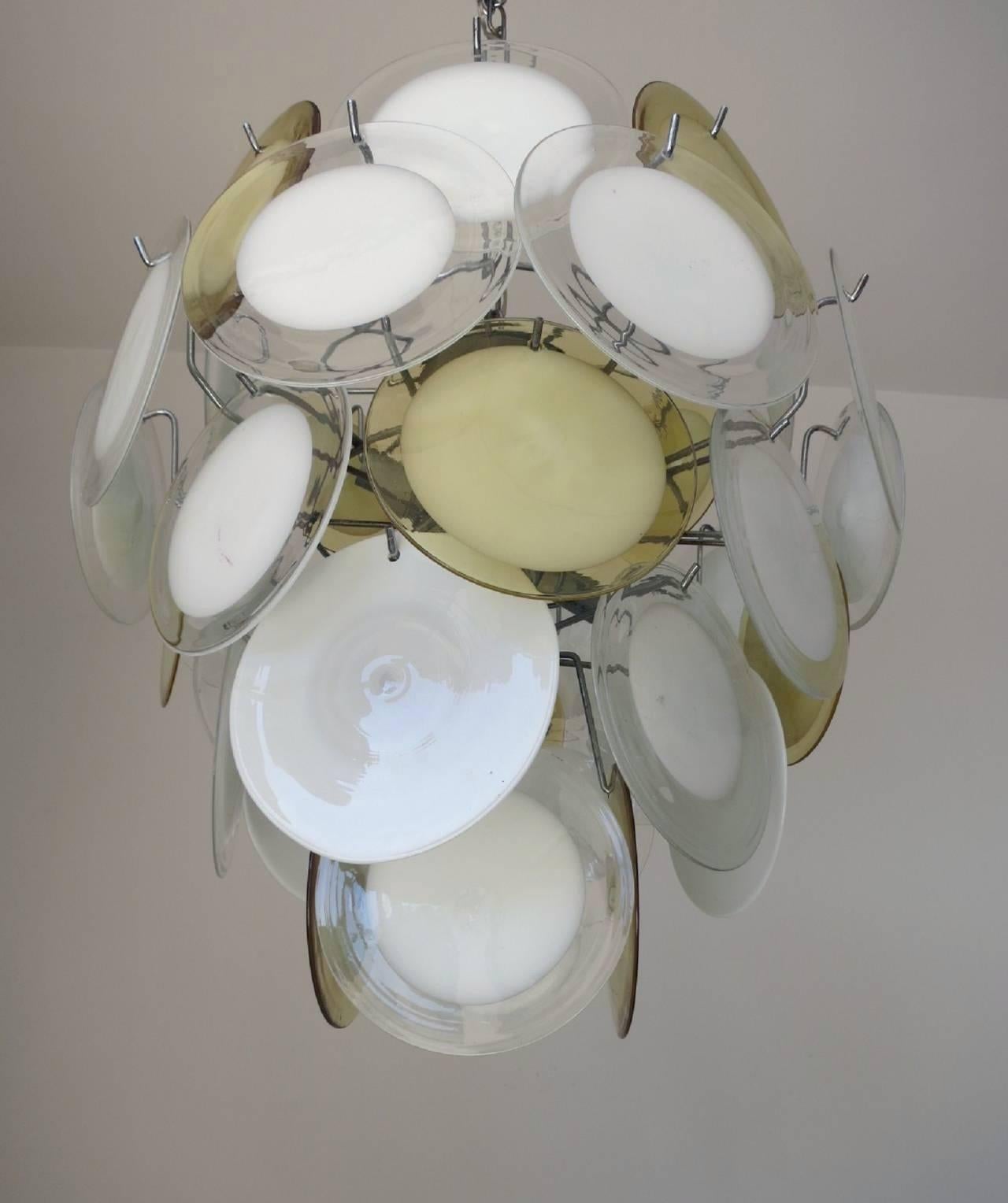 Italian Murano glass discs chandelier by Vistosi.
Seven candelabra light sockets; wired for the U.S.