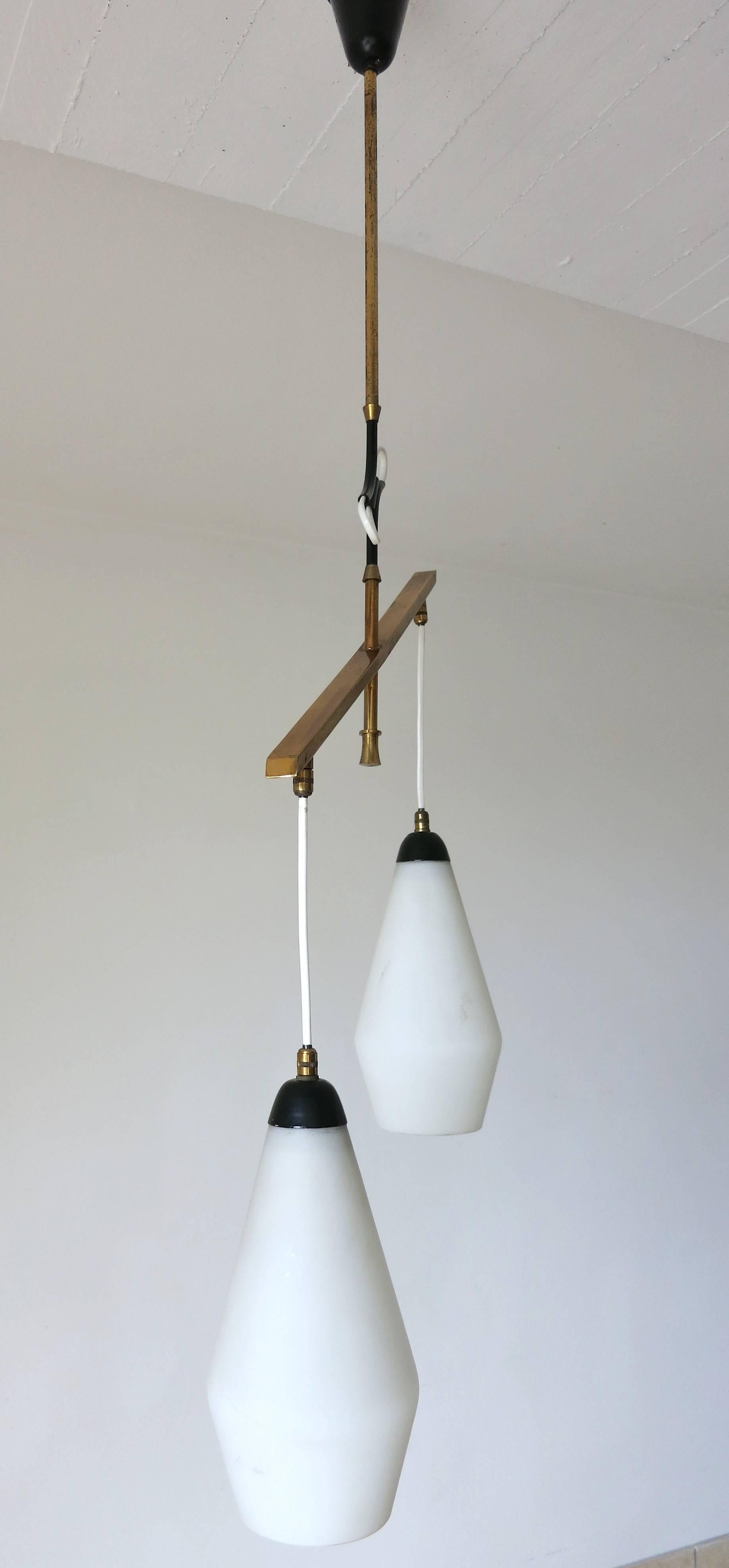 Italian vintage pendant with two matte white Murano glasses hand blown in to cylindrical shape, mounted on brass frame and black enameled details / Designed by Stilnovo circa 1960’s / Made in Italy
2 lights / E12 or E14 type / max 40W each
Width: