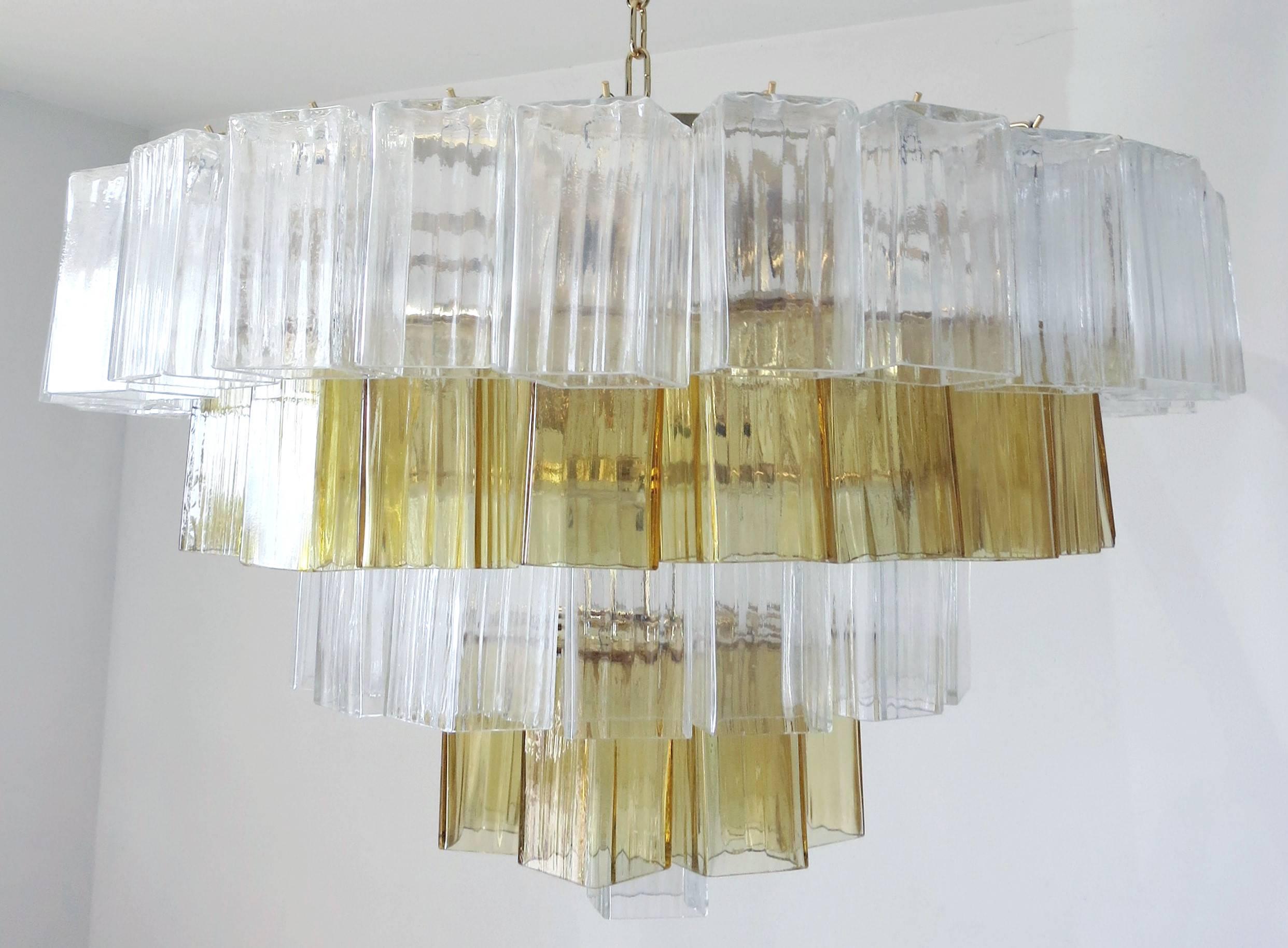 Italian Murano glass chandelier.
Vintage clear and amber hand blown Murano glass pieces, on a newly made 24-karat gold-plated frame.
Nine light sockets.

This item is located in Fabio Ltd warehouse in Italy.
Note: this item ships from Italy.