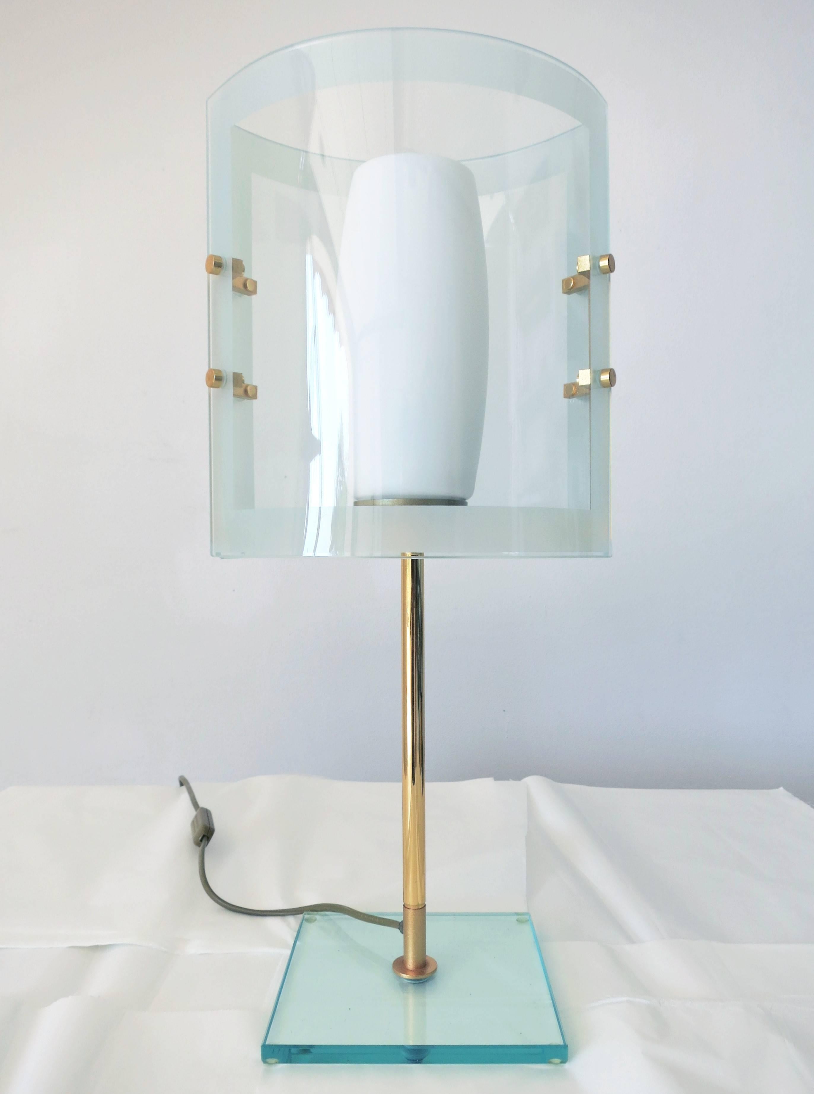 Italian vintage table lamp, made with beveled glass, frosted glass, and brass, in the style of Fontana Arte.
Single light socket.

A pair of different sizes available. 
The lamp in this listing is the smaller one of the pair, has size height