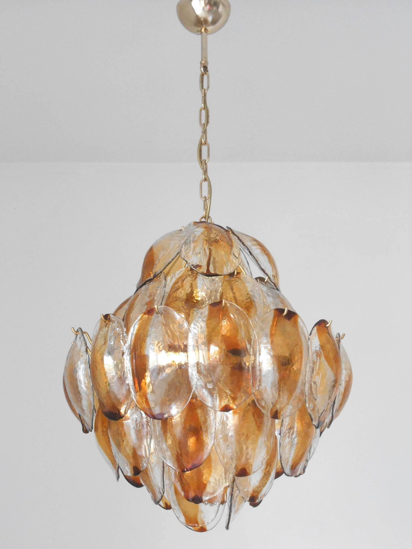 Italian vintage chandelier by La Murrina, with amber Murano glass shells. Original mark on some of the glass pieces.
Twelve-light sockets, wired for the U.S.