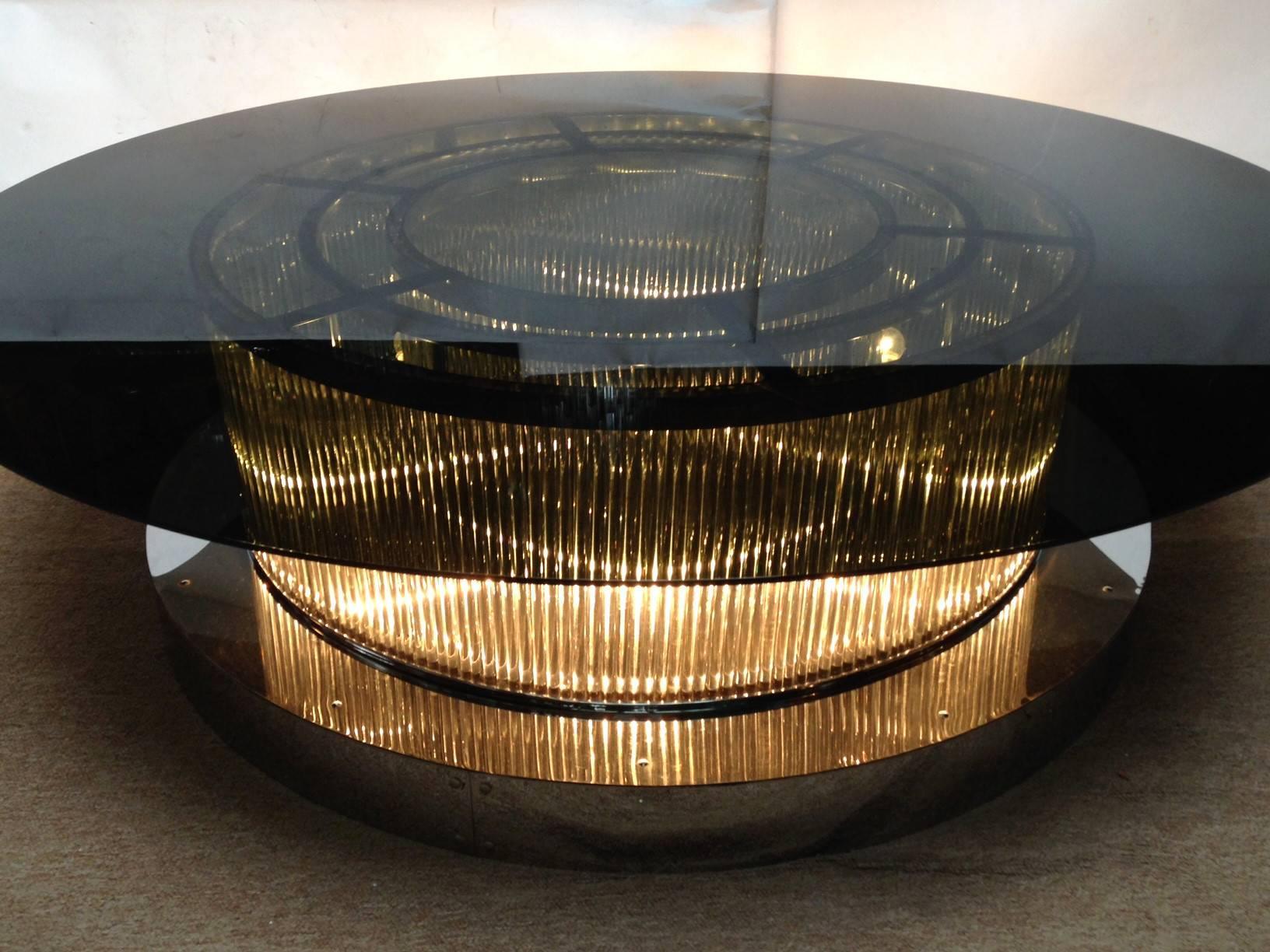 One of a kind Italian over sized crystal bars coffee table with chrome base and glass top by Fabio Bergomi for Fabio Ltd.
This table can be lit up from inside with it's six standard light sockets wired for the U.S.
Top glass diameter is 60