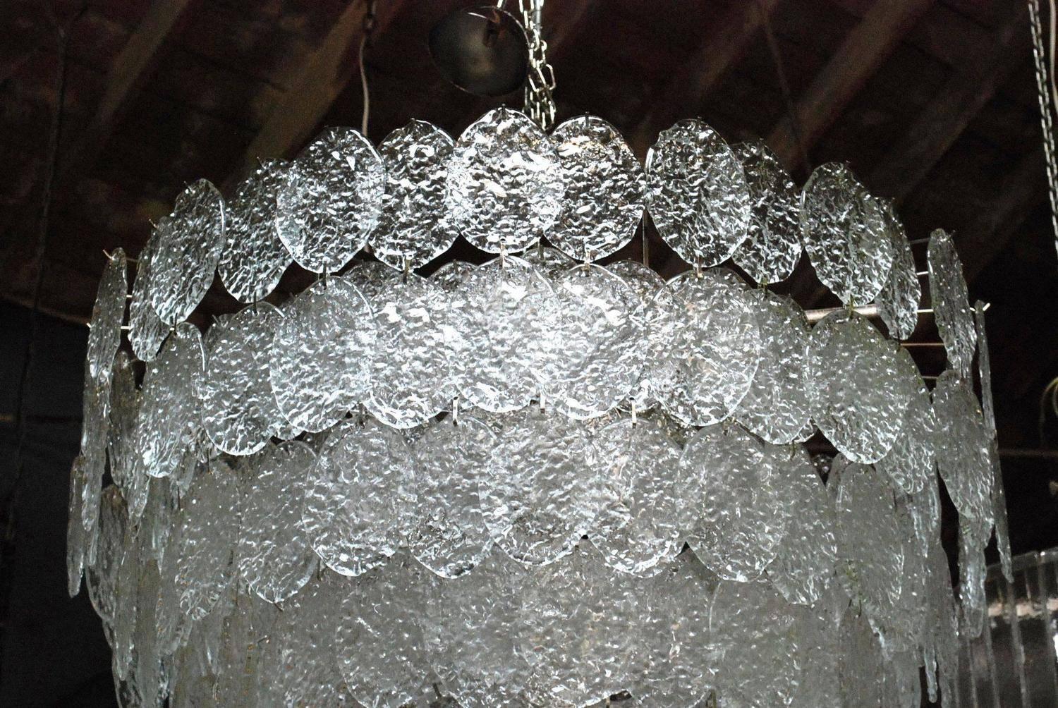 Vintage Italian chandelier with clear Murano oval discs mounted on a nickel frame, made in Italy, circa 1960s
28 lights / E26 or E27 type / max 60W each
Measures: Diameter 44 inches, height 44 inches plus chain and canopy
1 in stock in Palm Springs