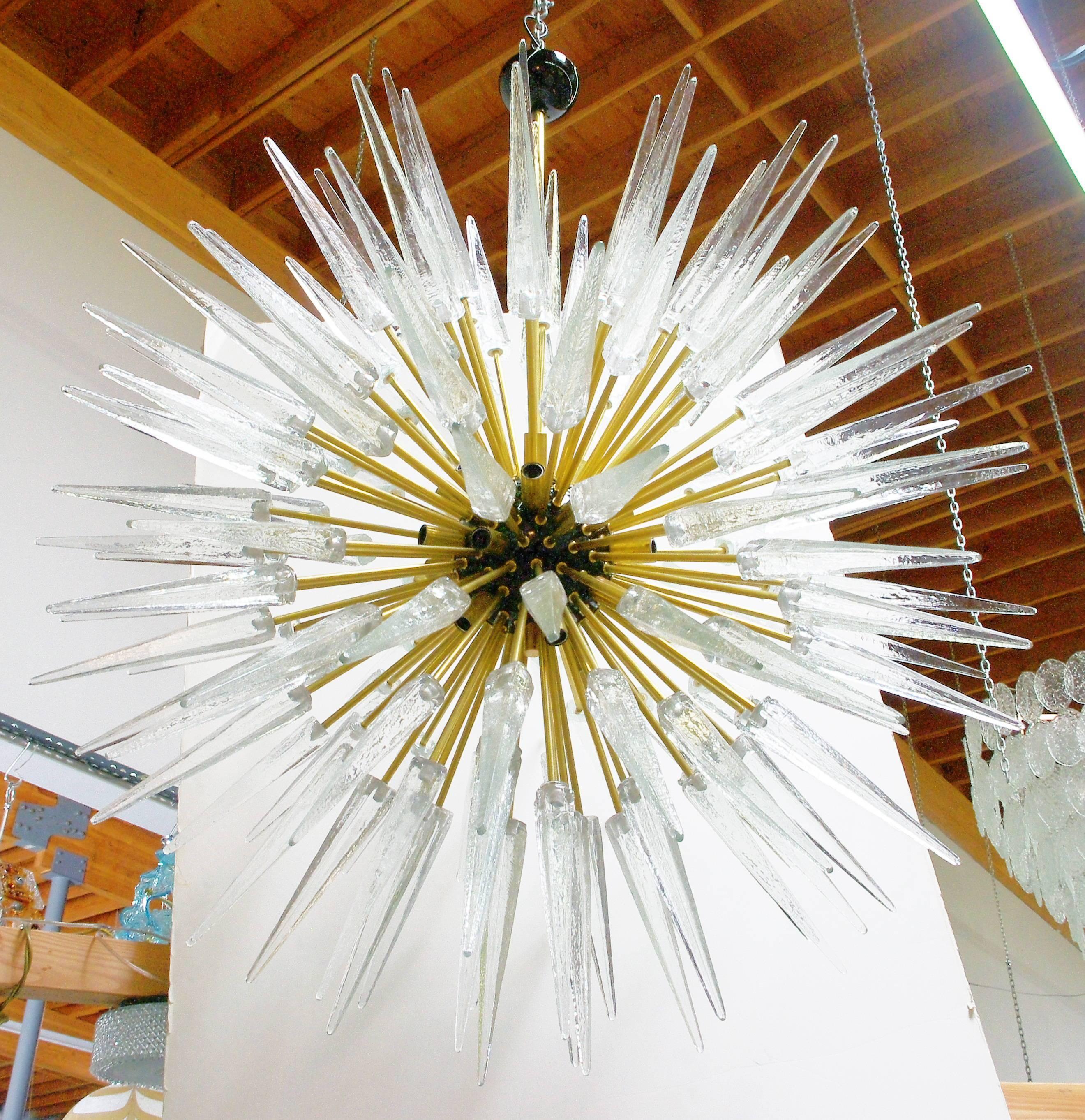 Italian modern Sputnik chandelier shown with clear Murano glass shards, black enameled centre, mounted on brass frame / Designed by Fabio Bergomi for Fabio Ltd / Made in Italy 
12 lights / E12 or E14 type / Max 40W each
Diameter: 52 inches / Height: