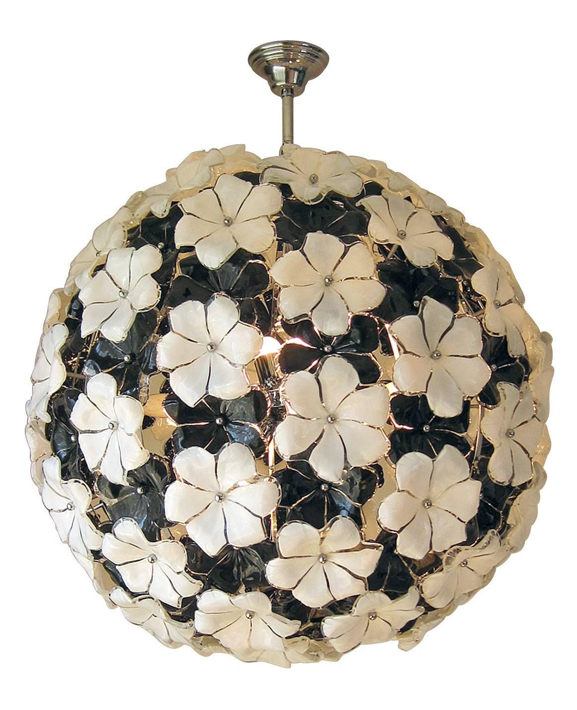 Italian chandelier with 145 unique black and white Murano glass flowers, each individually handblown and mounted on a chrome frame / Designed by Gino Cenedese circa 1970’s / Made in Italy 
12 lights / E26 or E27 type /  max 40W each
Diameter: 31.5