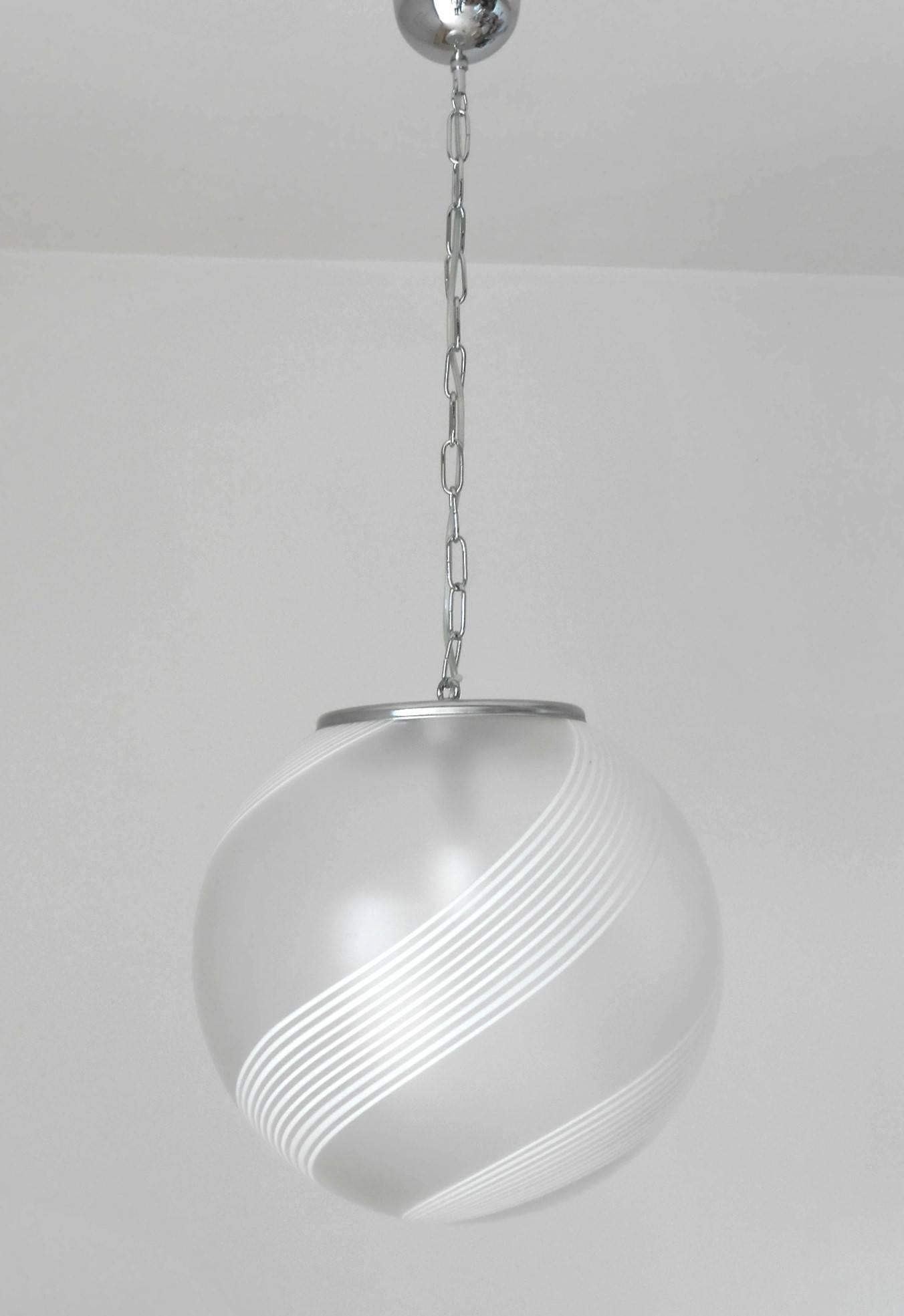 Vintage Italian pendant with frosted Murano glass globe with hand blown white Murano glass stripes, mounted on chrome hardware / Designed by Venini circa 1960’s / Made in Italy
1 light / E26 or E27 type / max 60W 
Diameter: 16 inches / Height: 16
