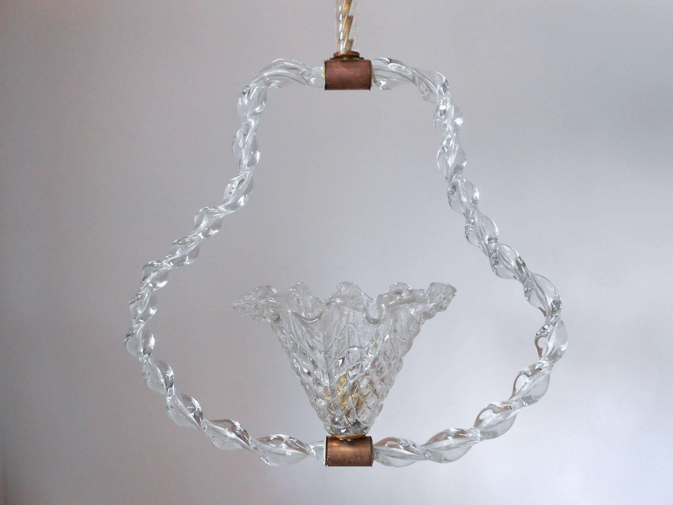 Vintage Italian pendant chandelier with textured clear Murano glass bell surrounded by a twisted glass, glass rod and canopy, mounted on brass hardware / Designed by Ercole Barovier circa 1950’s / Made in Italy
1 light / E26 or E27 type / max
