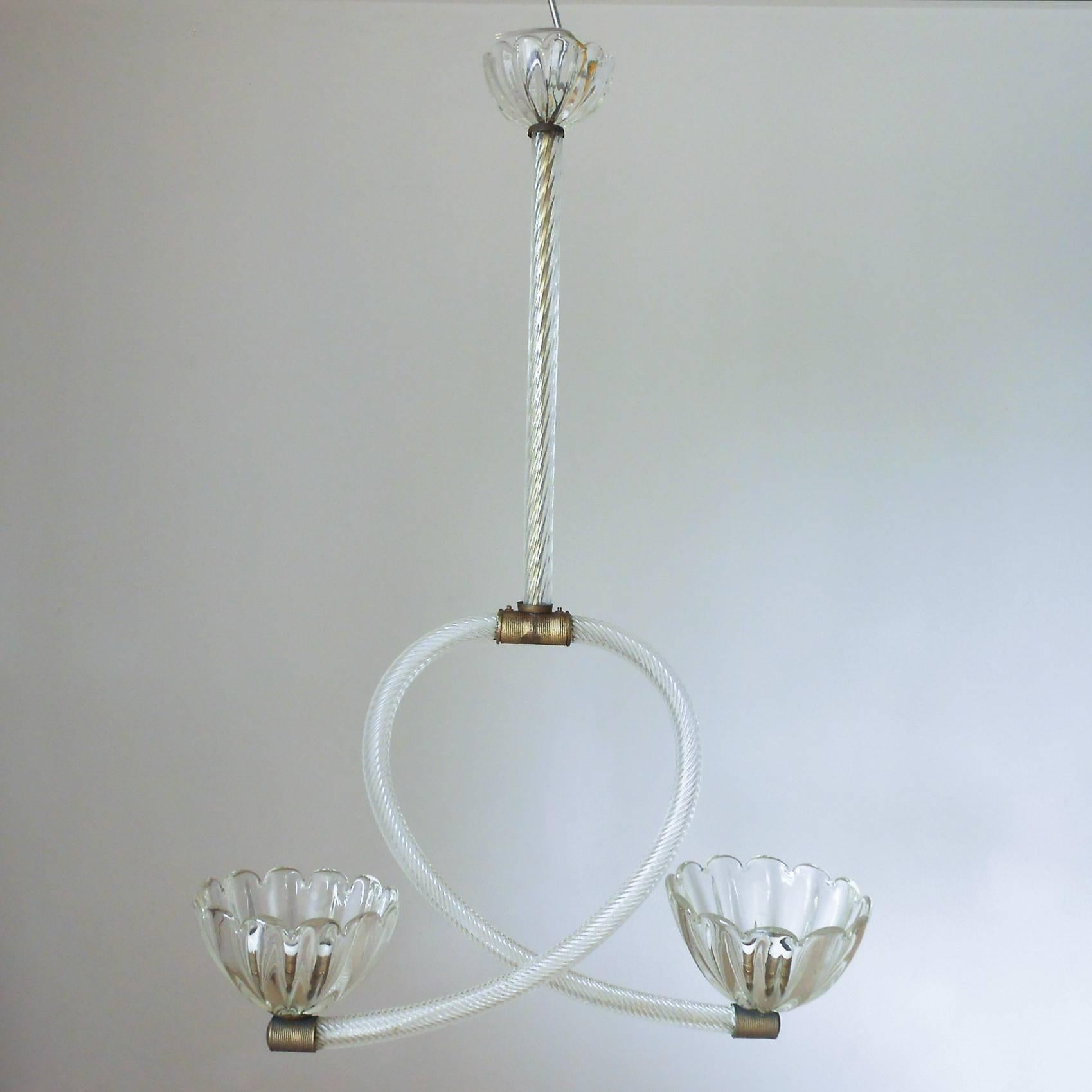 Vintage Italian pendant with clear ribbed Murano glass arms and two scalloped shaped cups and canopy, mounted on bronze hardware encased in ribbed Murano glass / Designed by Barovier e Toso circa 1950’s / Made in Italy
2 lights / E26 or E27 type /