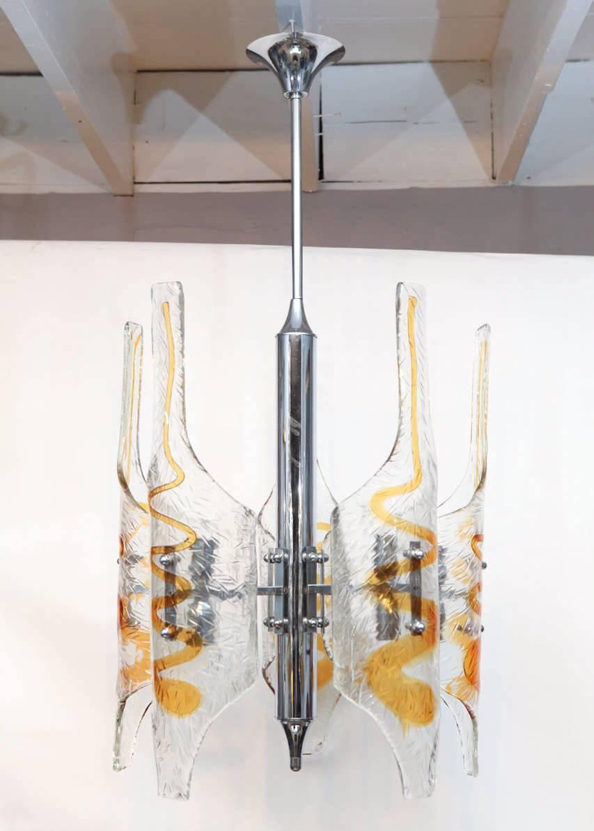 Italian pendants chandelier with clear and amber Murano glass shades hand blown into tubular shapes, mounted on chrome frame / Designed by Mazzega circa 1970s / Made in Italy
10 lights / E12 or E14 type / max 40W each
Diameter 22 inches / Height 42