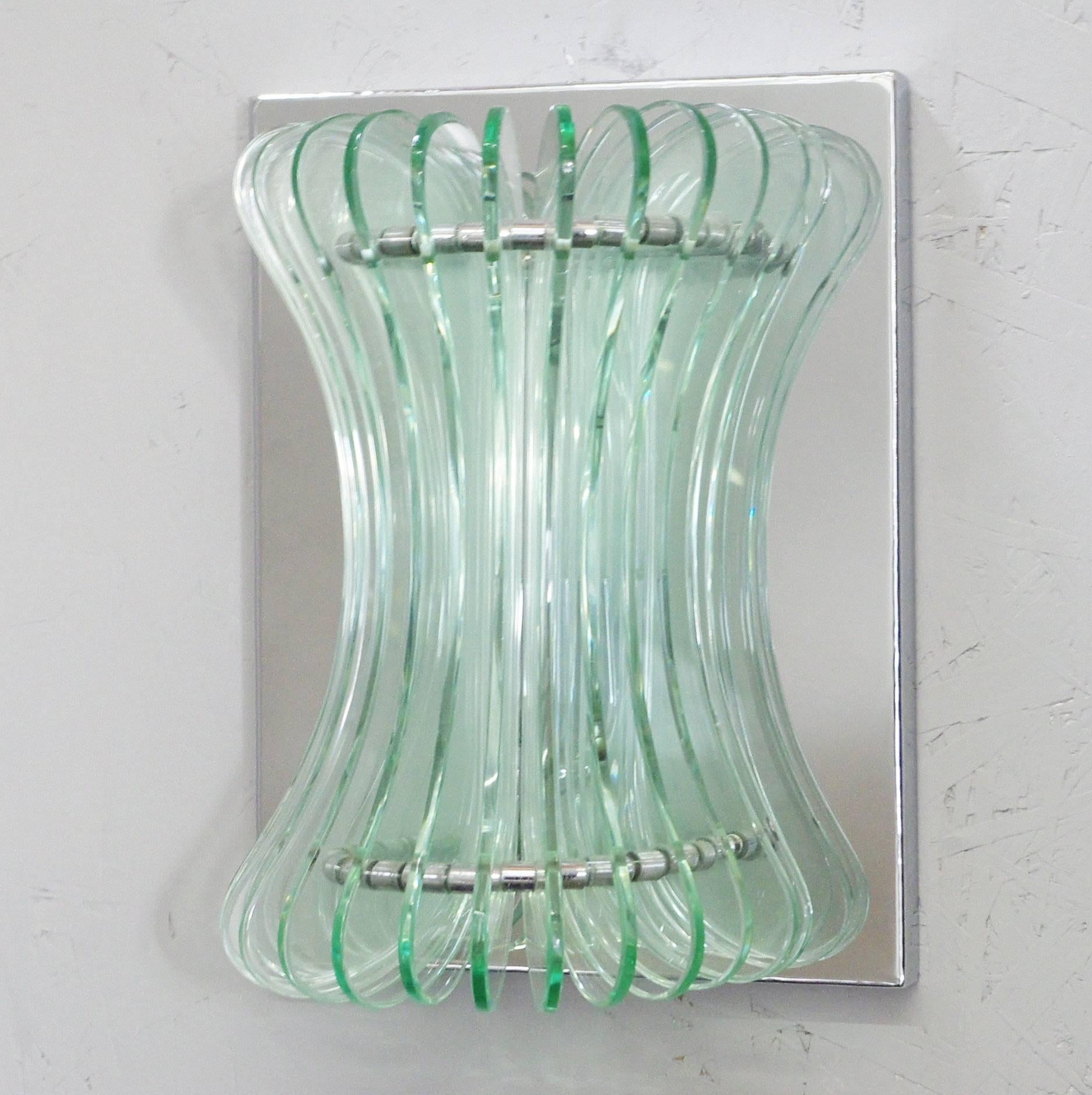 Vintage Italian wall lights with beveled glasses mounted vertically on polished chrome back plates / Designed by Cristal Arte, circa 1960’s / Made in Italy
1 light / E12 or E14 type / max 40W each
Height: 12 inches / Width: 9.5 inches / Depth: 5.5