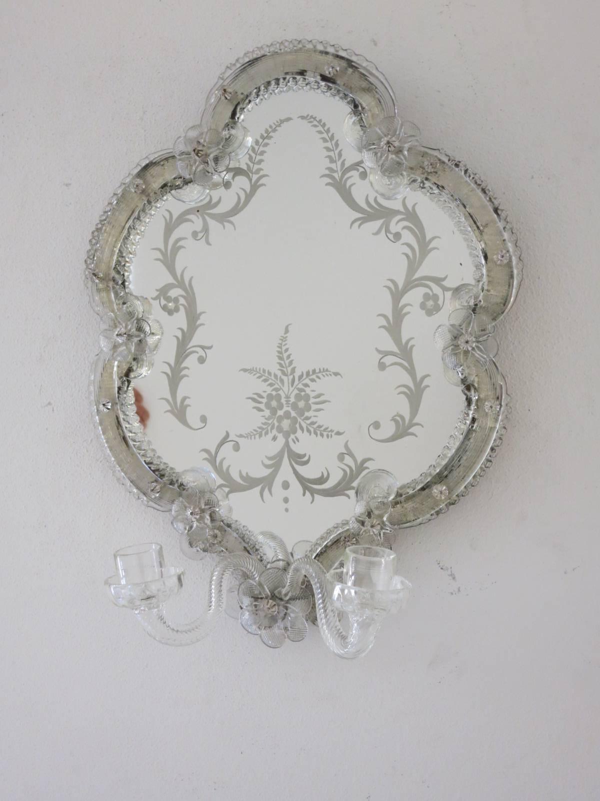 Vintage Italian Rococo Revival mirror wall sconces hand blown in clear Murano glass with decorative details, antiqued patina on mirror, mounted on wood back frame / Made in Venice Italy in the 1900s
2 candles each sconce
Height: 16 inches / Width: